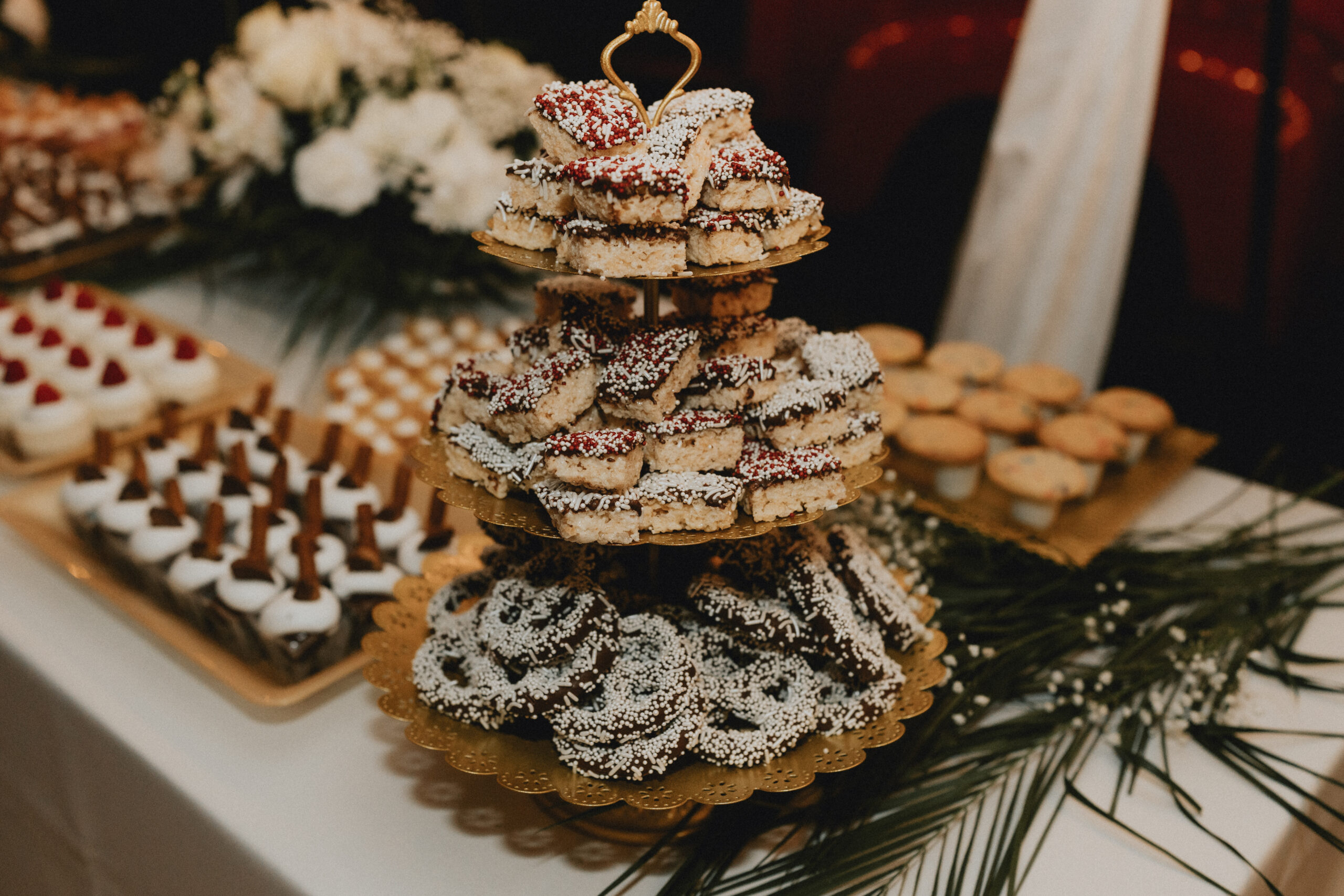 Elegant dessert table with layered pastries, chocolate-dipped treats, and gourmet sweets.