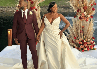 Elegant South Florida lakeside wedding with pampas grass and rose arch at Saint Patrick Palace.