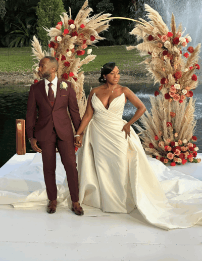 Elegant South Florida lakeside wedding with pampas grass and rose arch at Saint Patrick Palace.