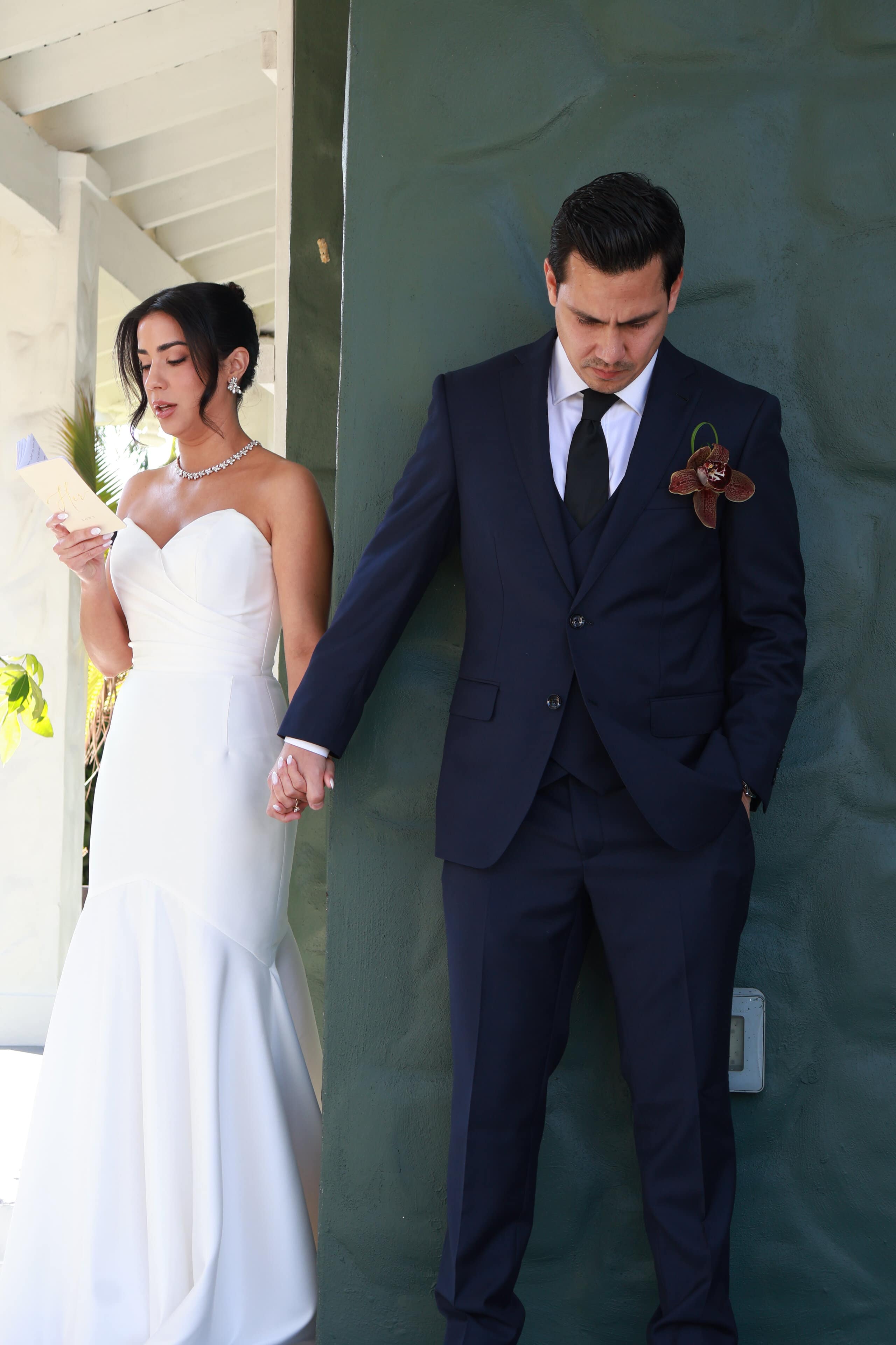 Bride and groom first touch reading vows before ceremony at Saint Patrick Palace