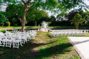 Green and cream floral arch and white aisle runner set for an elegant outdoor ceremony at Saint Patrick Palace.