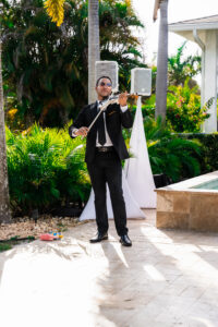 Violinist performing at outdoor wedding reception at Saint Patrick Palace, Davie Florida.