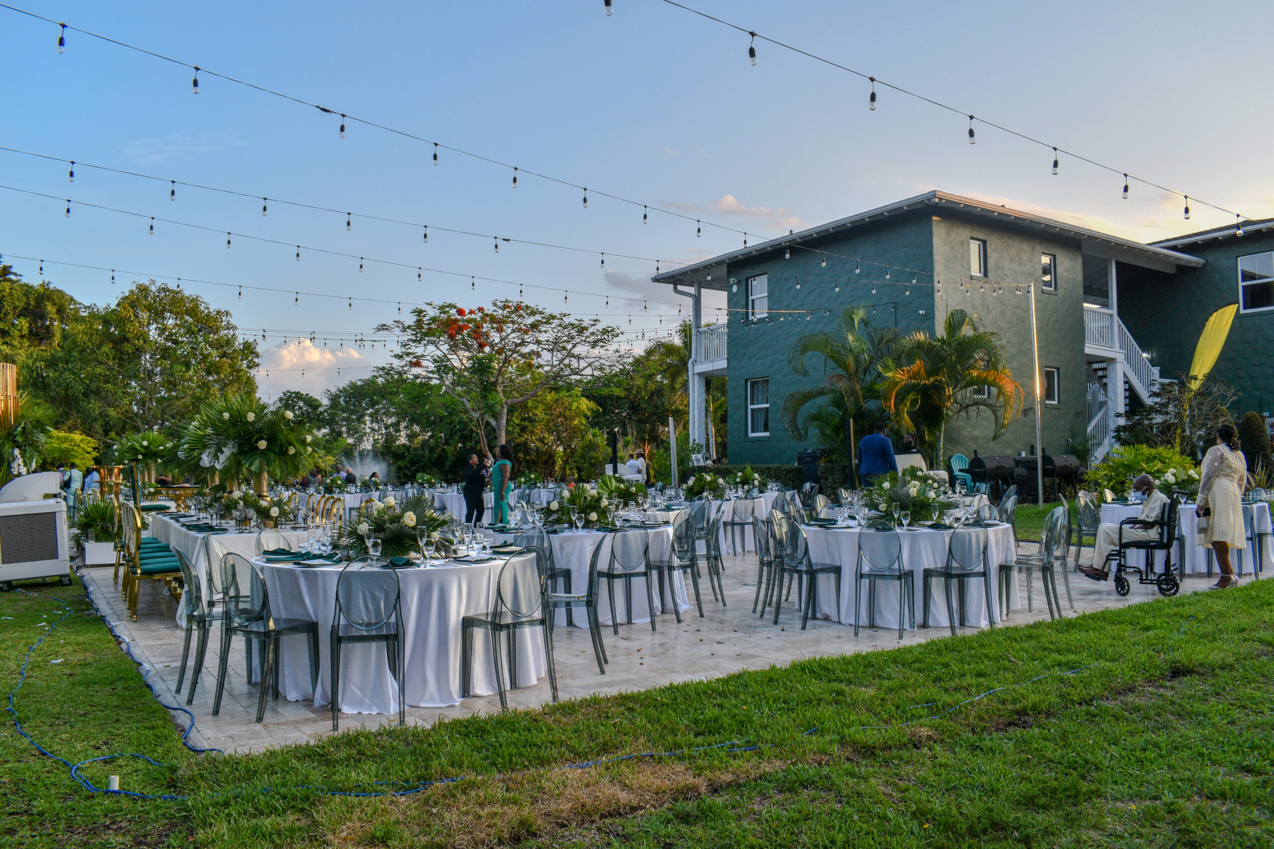 Outdoor wedding reception setup under string lights at Saint Patrick Palace