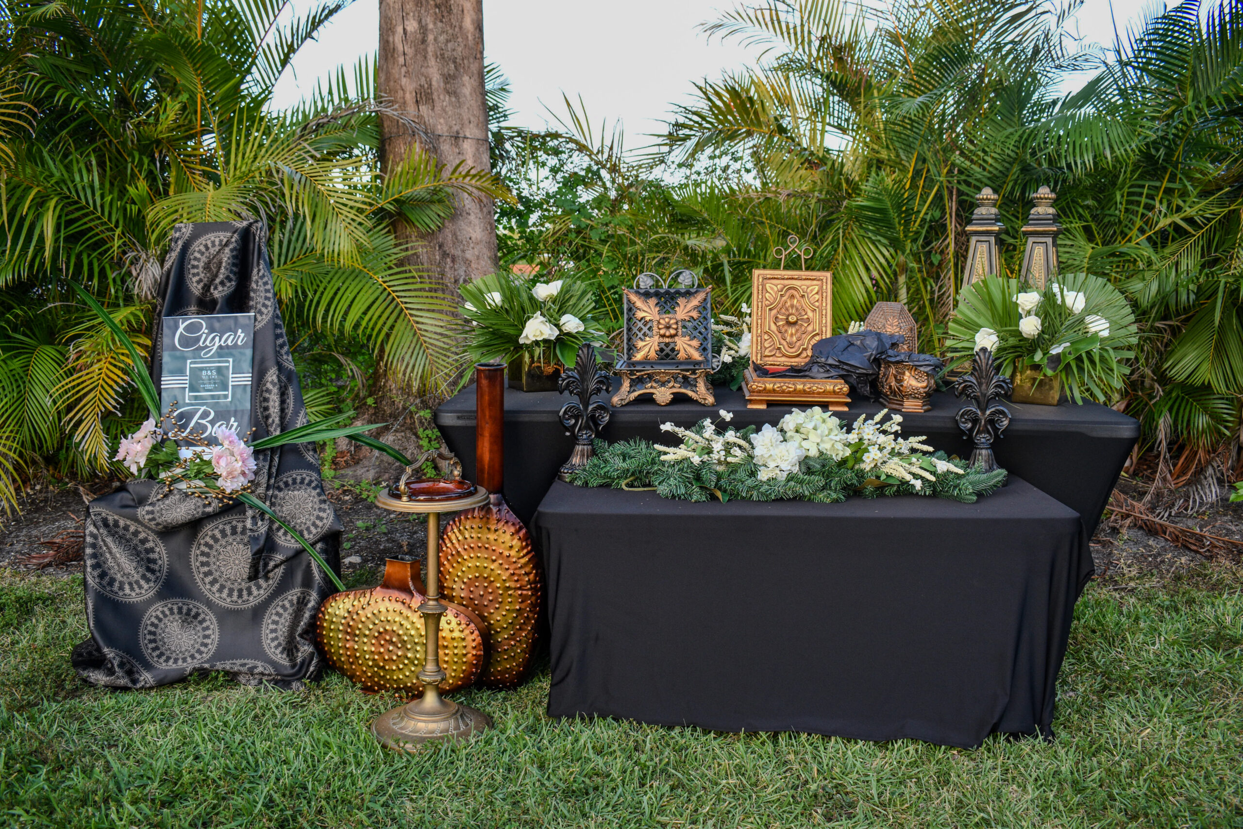 Cigar bar with gold accents, floral greenery, and vintage décor at Saint Patrick Palace in South Florida