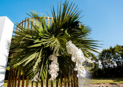 Palm leaves and orchids decorate gold backdrop at Saint Patrick Palace