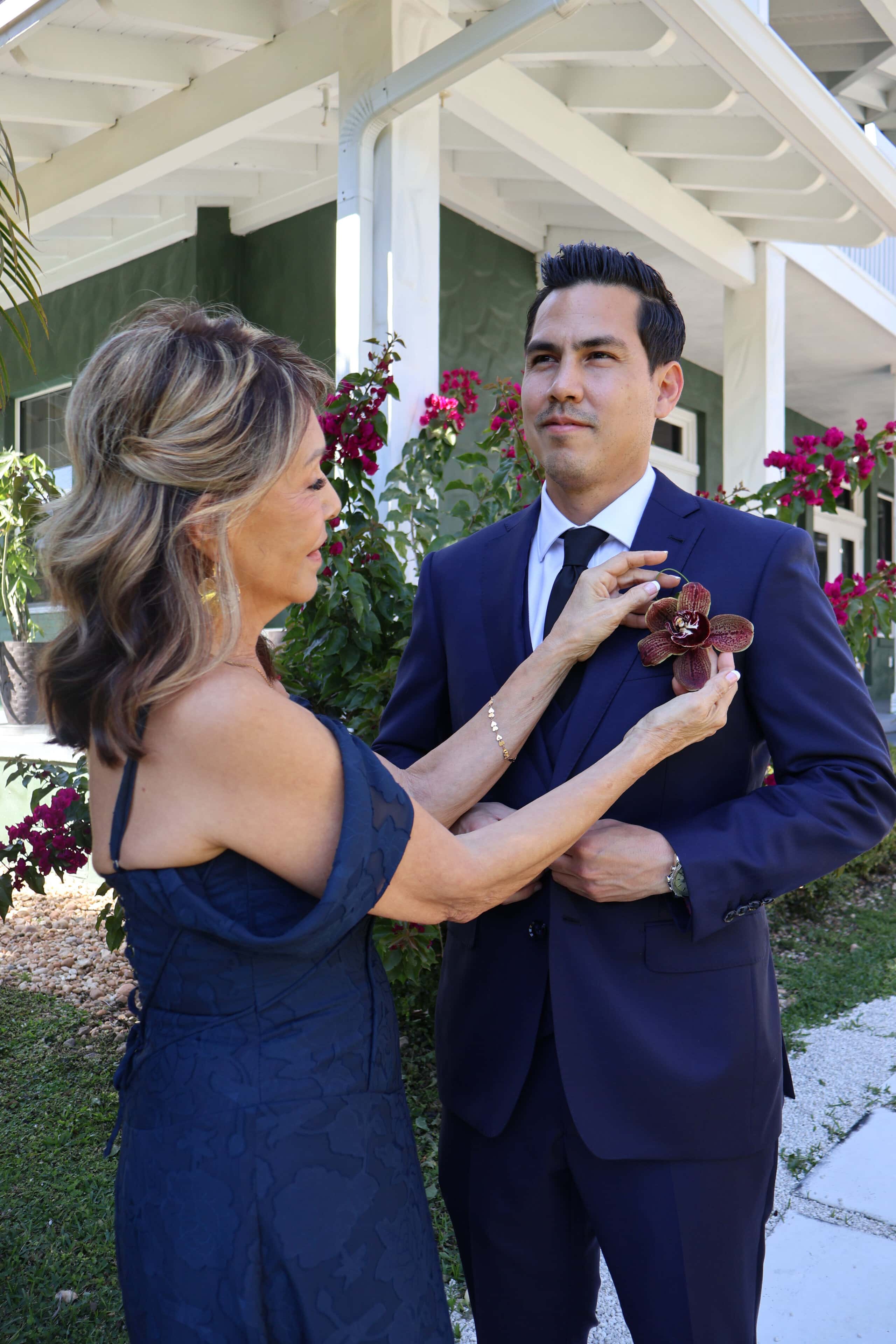Mother adjusting groom boutonniere before ceremony at South Florida wedding venue Saint Patrick Palace