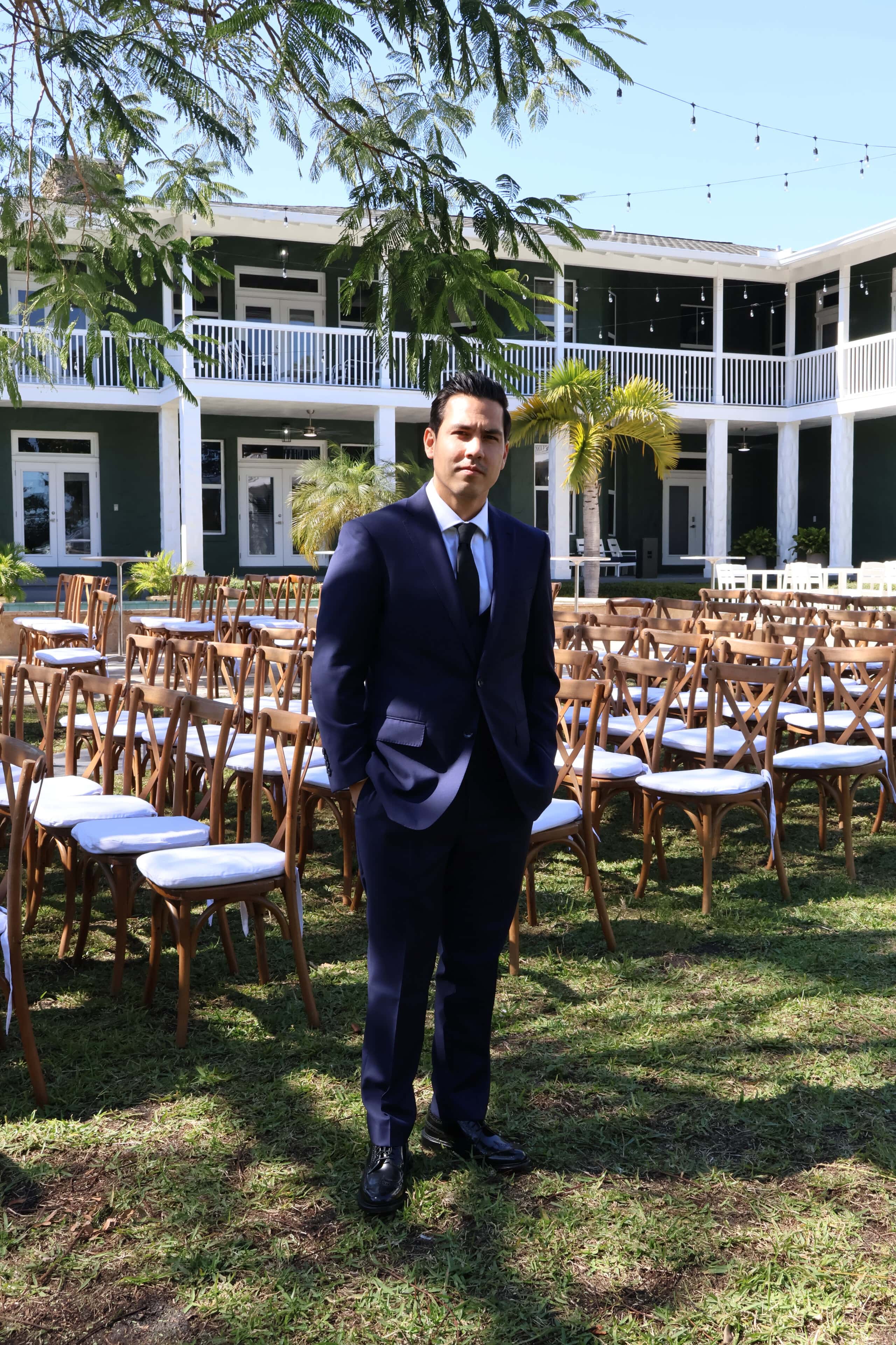 Groom standing in outdoor ceremony setup at Saint Patrick Palace wedding venue in South Florida