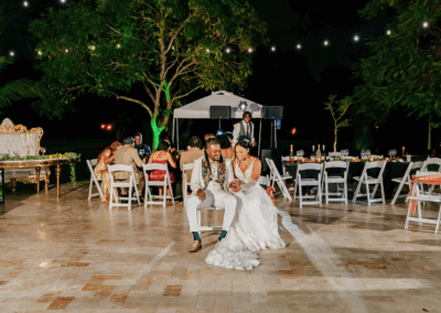 Bride and groom share a quiet moment during their intimate outdoor wedding reception under the stars.