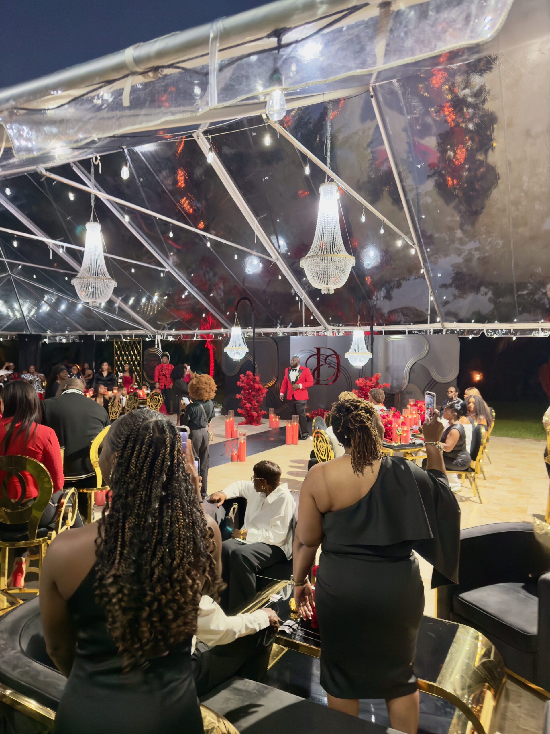 Luxury black and red tent celebration with chandeliers at Saint Patrick Palace.