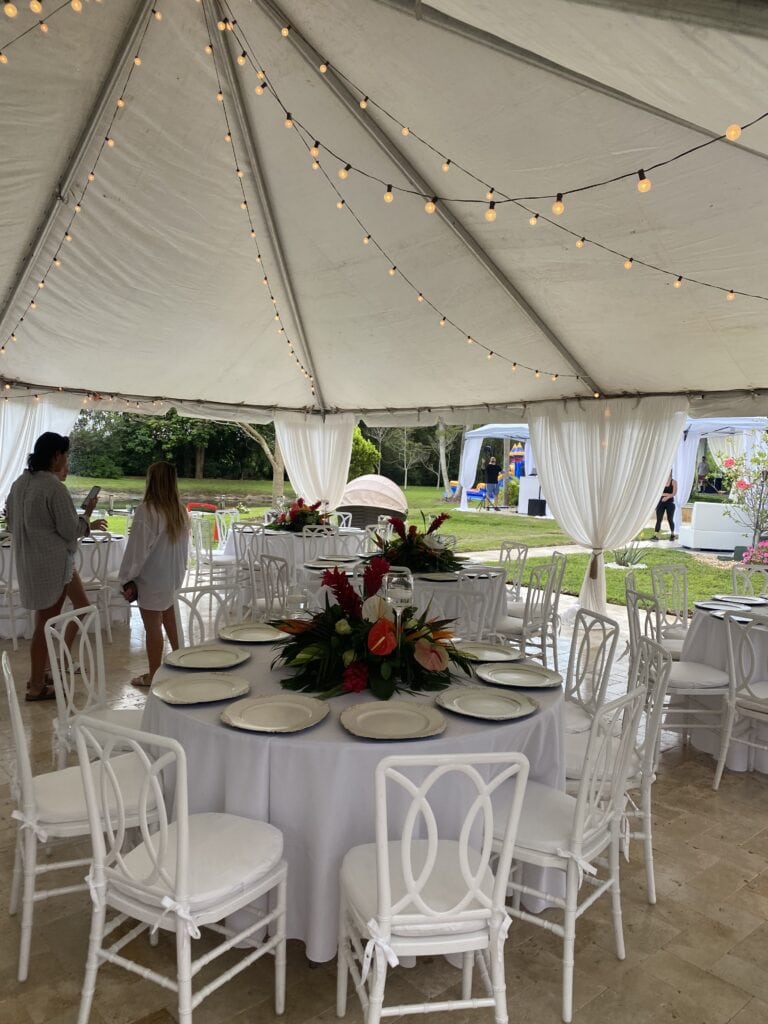 Elegant outdoor garden brunch tables with tropical centerpieces for a luxury 60th birthday celebration in South Florida.