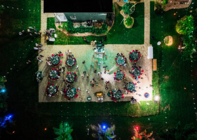 Aerial view of luxury outdoor wedding reception with string lights at South Florida estate venue.