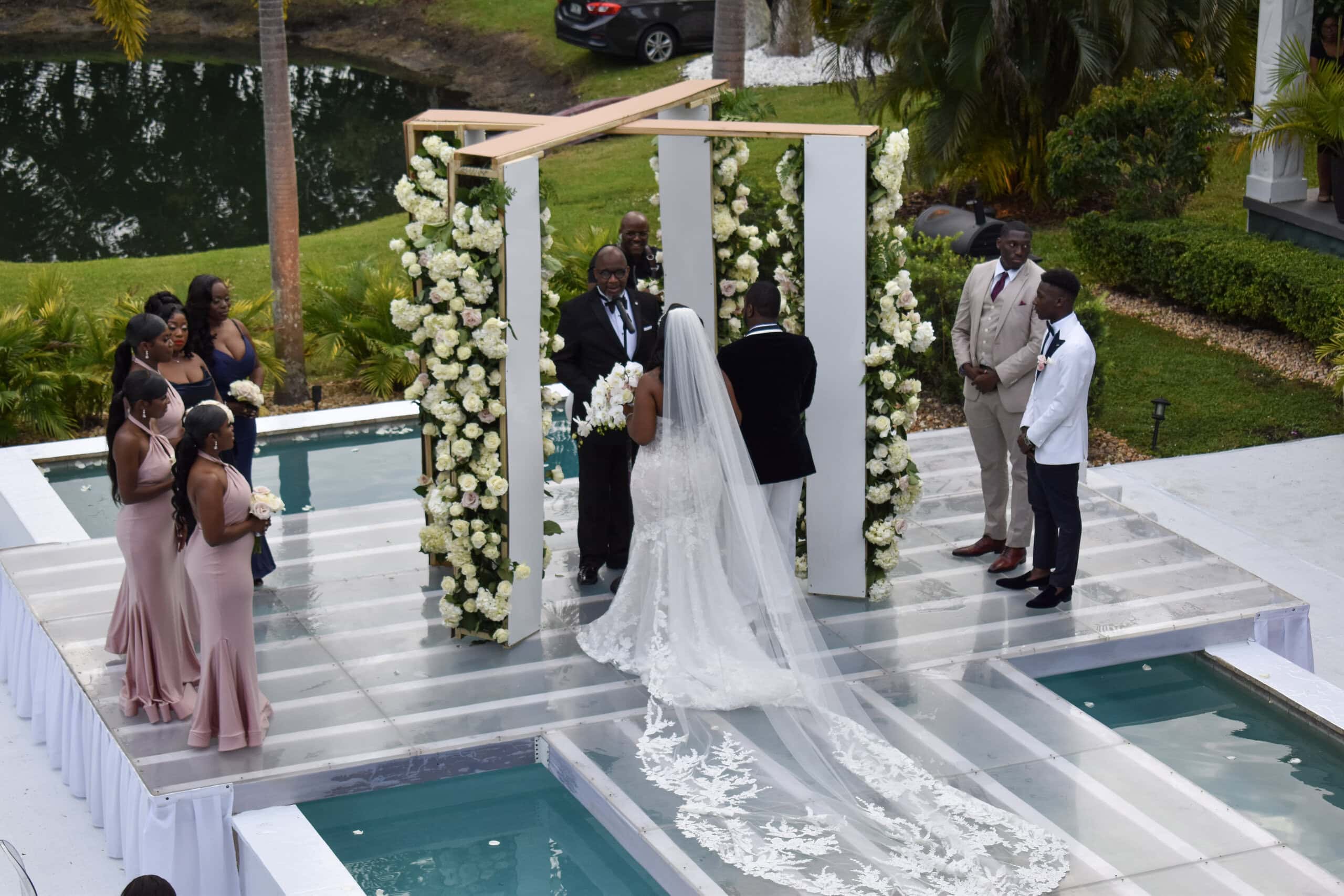 Luxury wedding ceremony over pool platform at Saint Patrick Palace in South Florida
