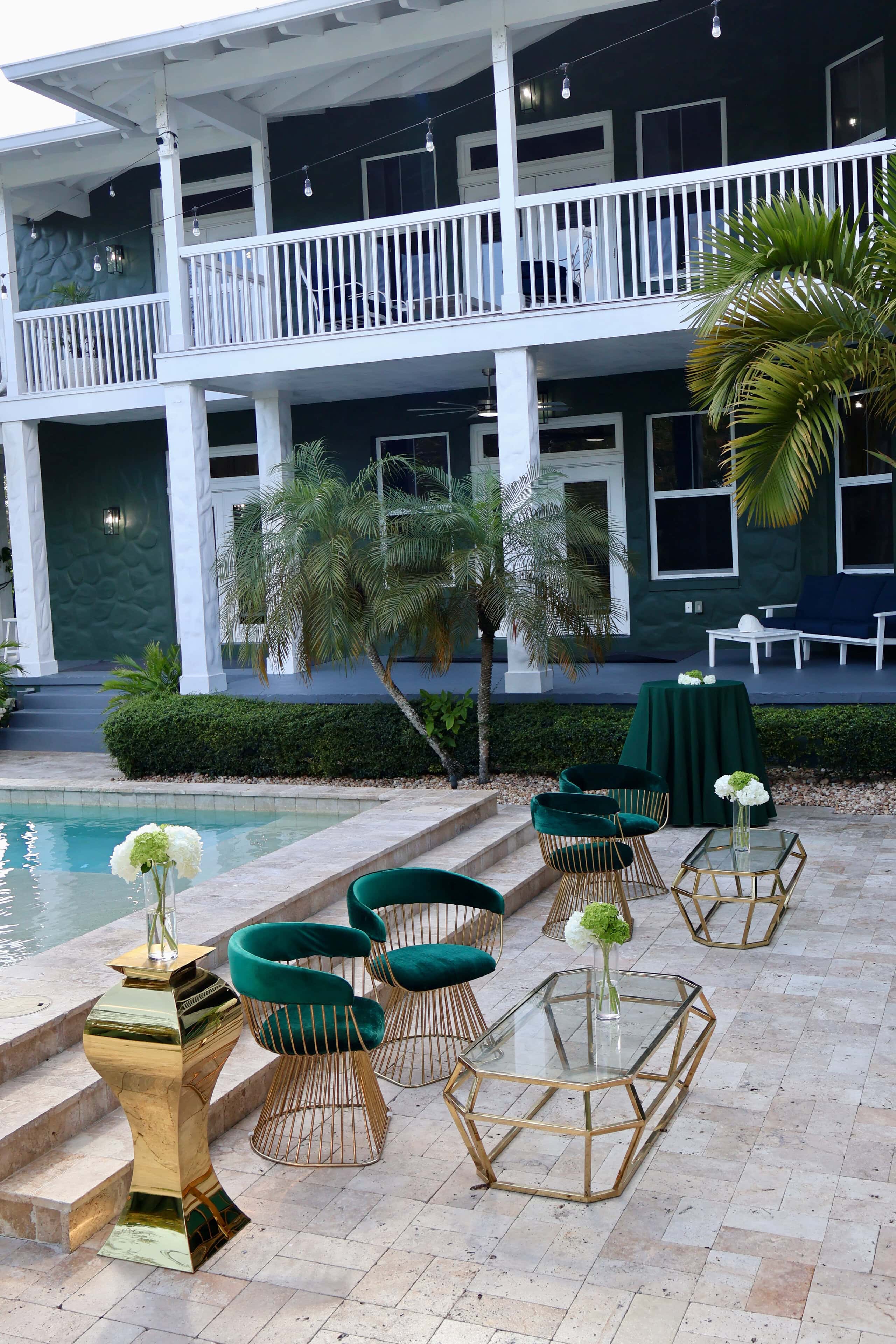 Elegant poolside lounge with velvet seating at a South Florida private estate for a luxury milestone birthday party.