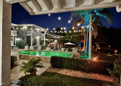Luxury poolside wedding venue with glowing lights at South Florida private estate.