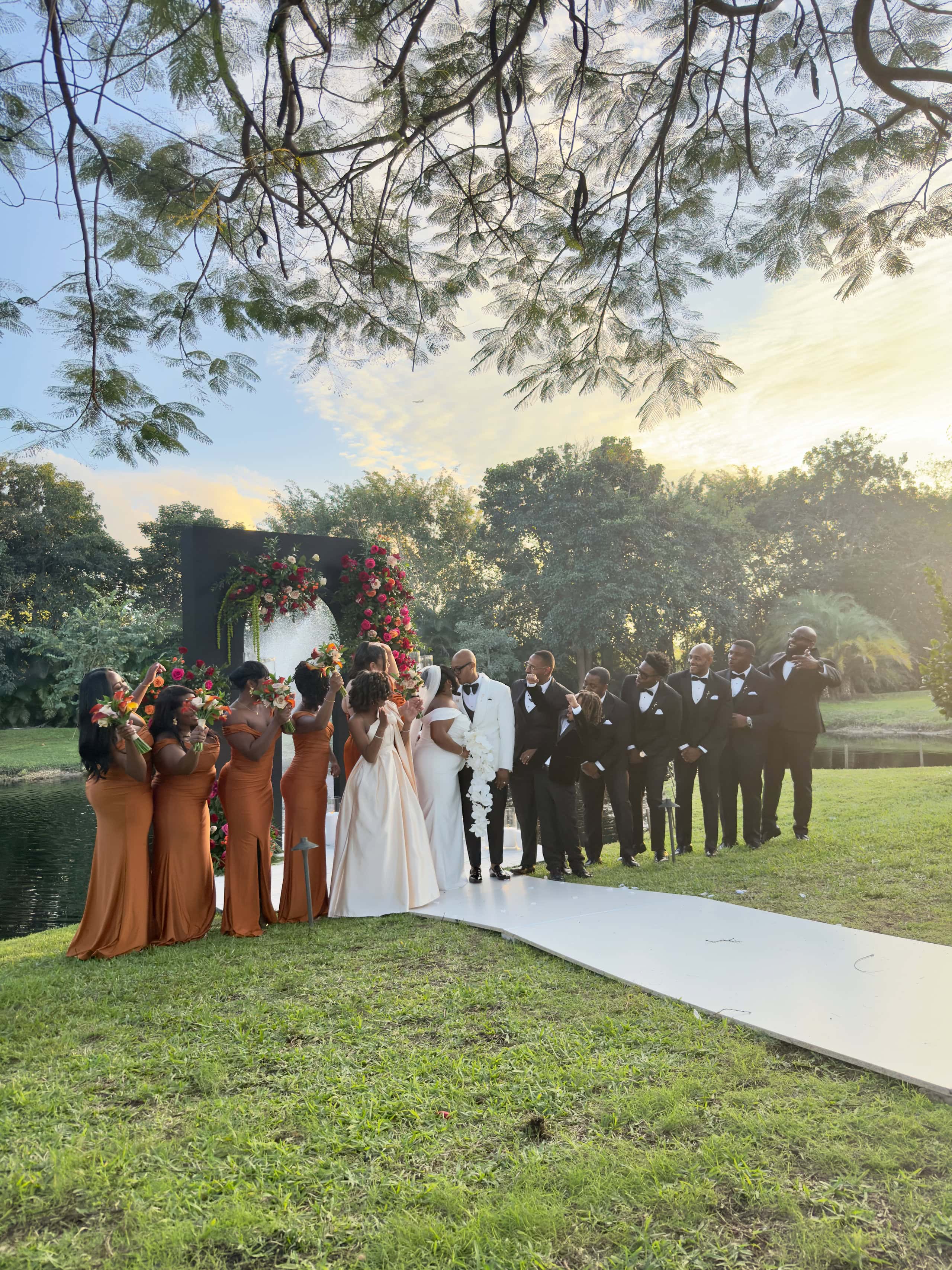 Full wedding party celebrating at a modern black-tie garden wedding in South Florida