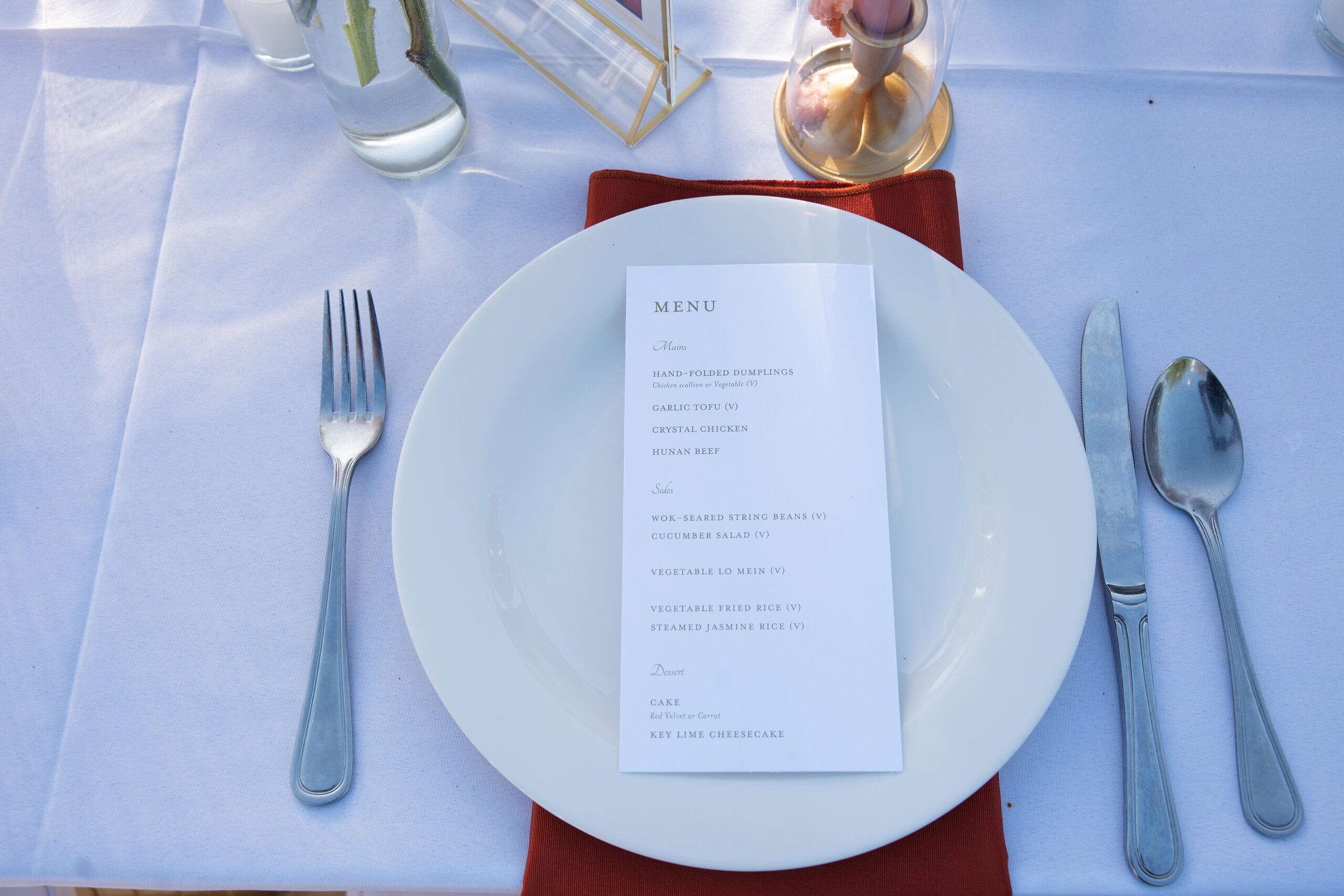 Custom wedding menu at place setting showing open vendor catering flexibility at Saint Patrick Palace outdoor reception