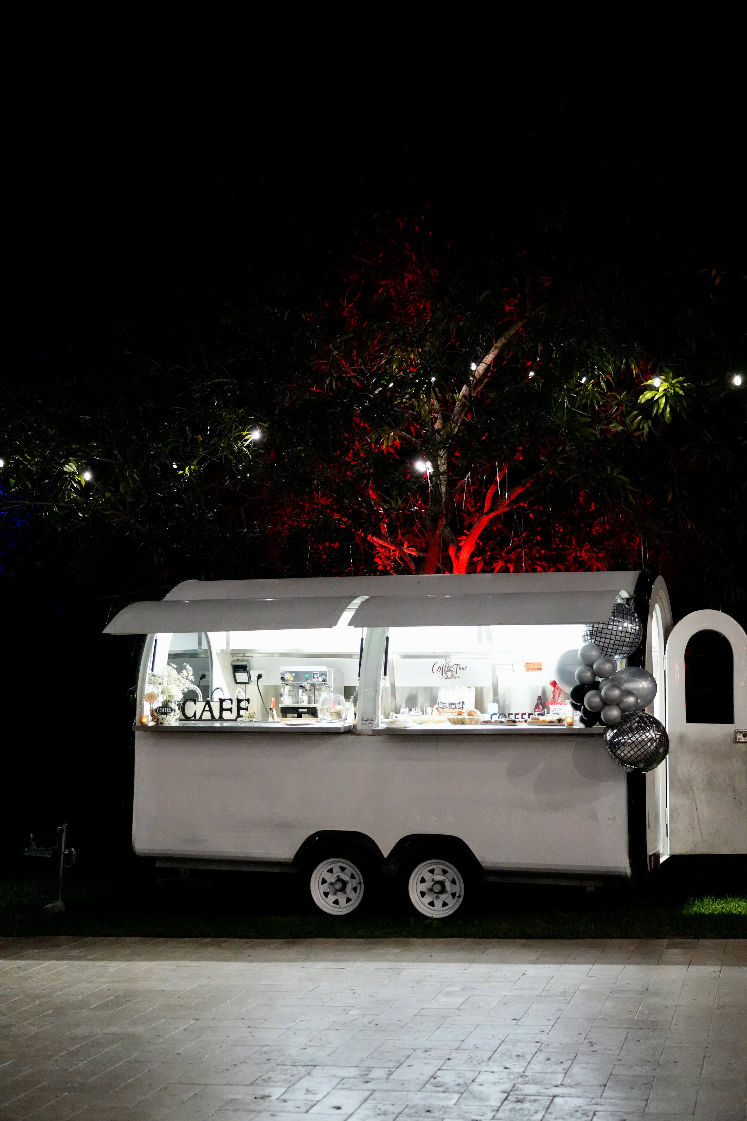 Outdoor coffee and dessert cart illuminated at night during a luxury wedding reception at Saint Patrick Palace in South Florida