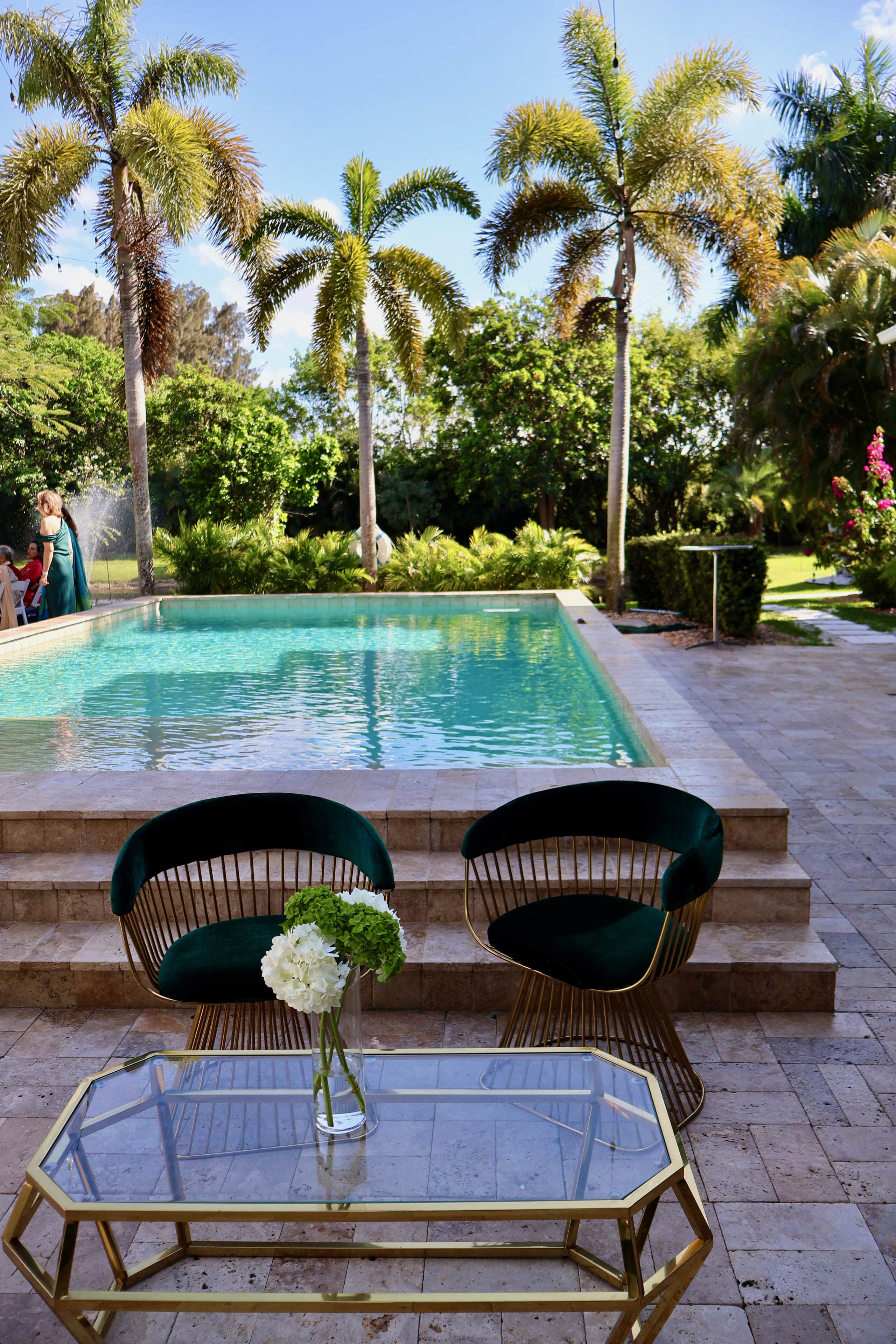 Luxury poolside lounge at a private estate in South Florida for an elegant summer milestone birthday celebration.