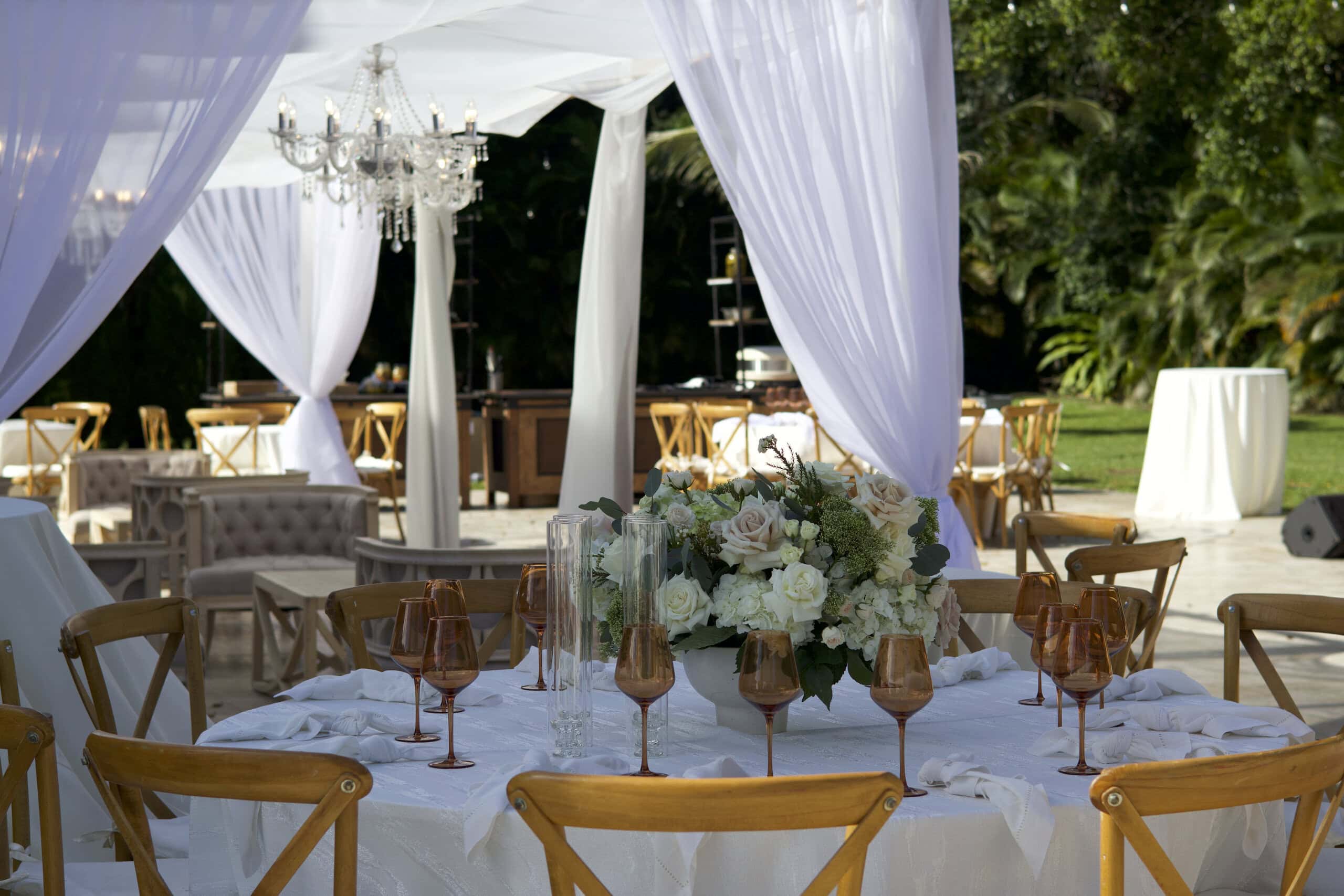 Elegant outdoor wedding reception with draping, chandeliers, and luxury seating at Saint Patrick Palace.