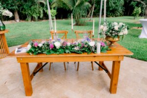 Sweetheart table with lavender flowers, greenery, and candles at a summer wedding in South Florida.