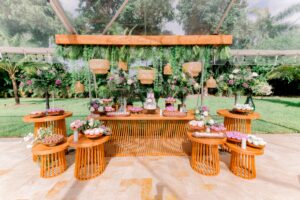 Lavender and greenery dessert display with wood tables and woven lanterns at a summer wedding at Saint Patrick Palace.