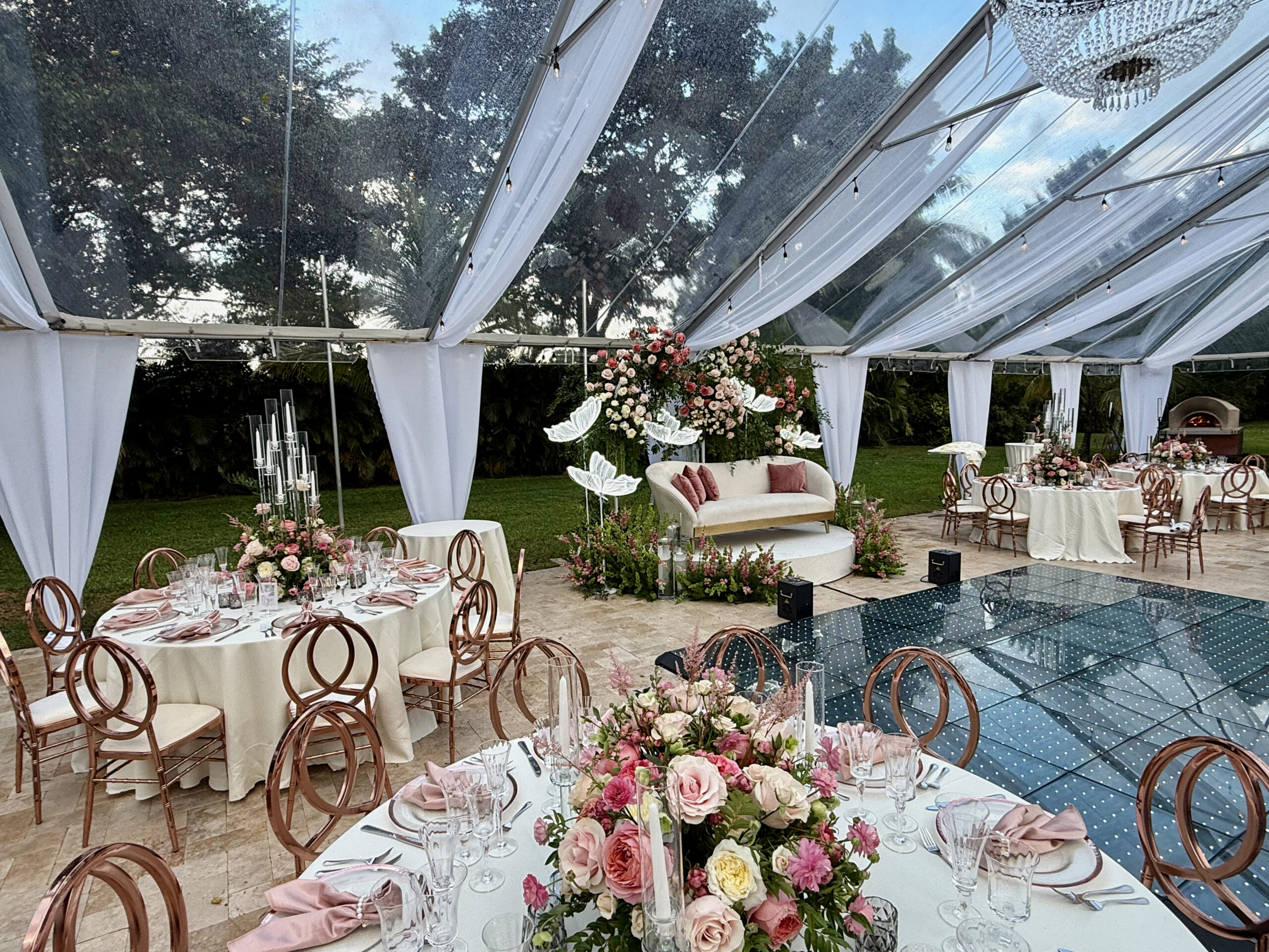Floral backdrop and LED dance floor at luxury quinceañera in South Florida.