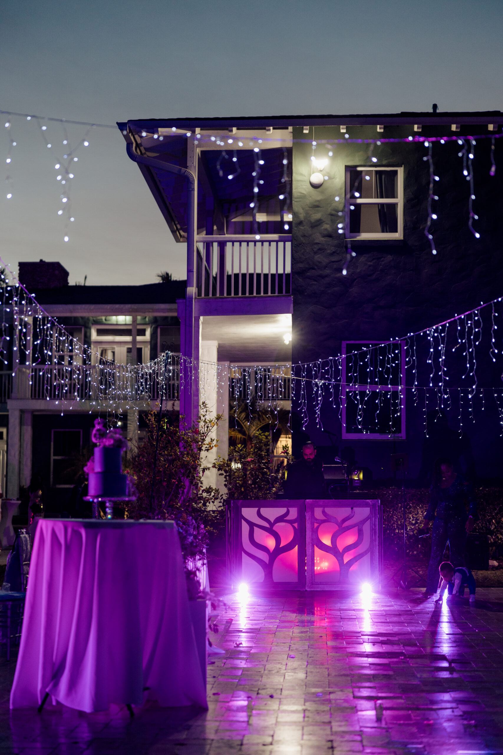 Quinceañera celebration with DJ, cake table, and glowing lights at luxury South Florida event venue.
