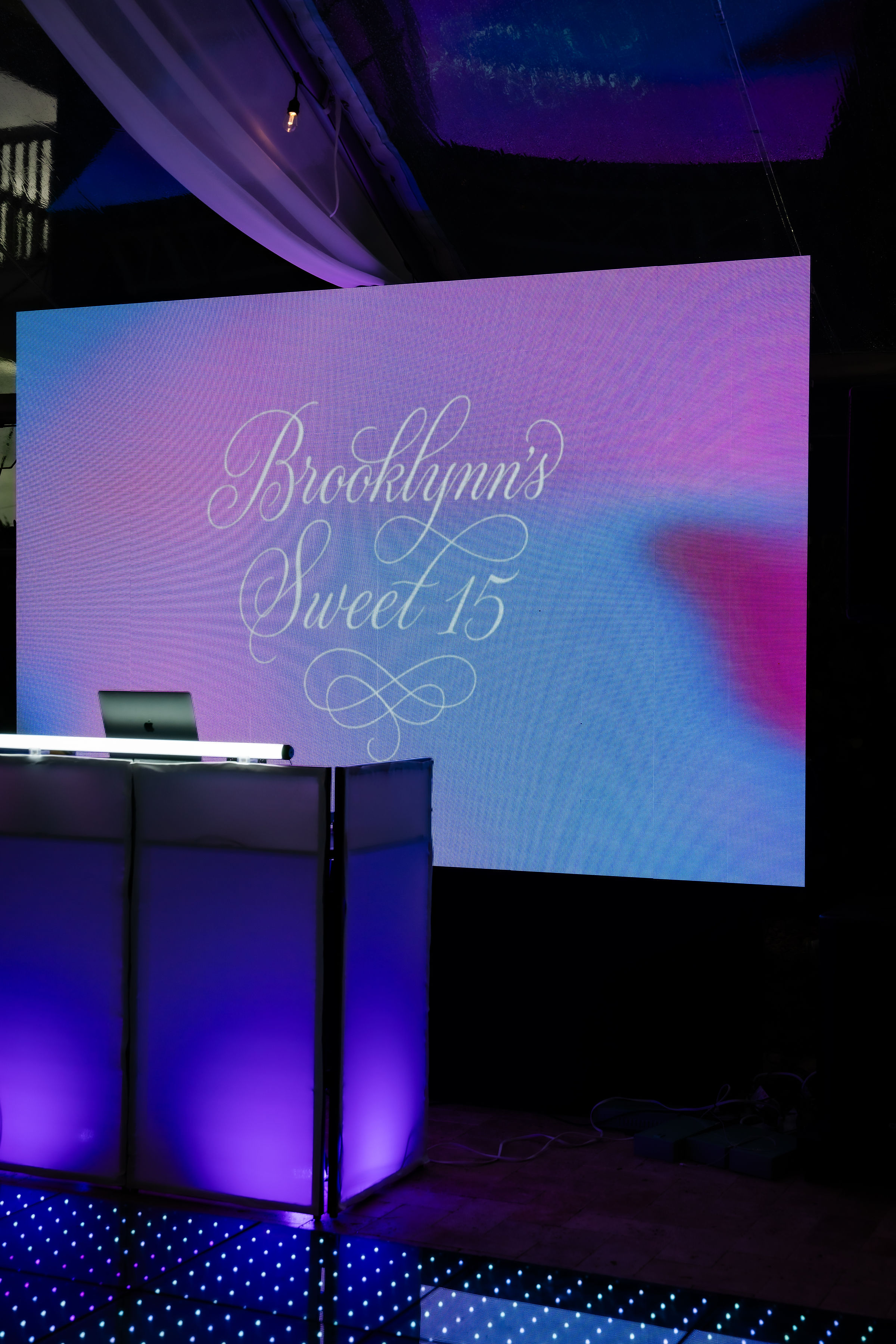 LED screen reading “Brooklynn’s Sweet 15” beside the DJ booth at Saint Patrick Palace quinceañera.