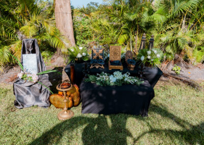 Cigar bar with gold accents, floral greenery, and vintage décor at Saint Patrick Palace in South Florida