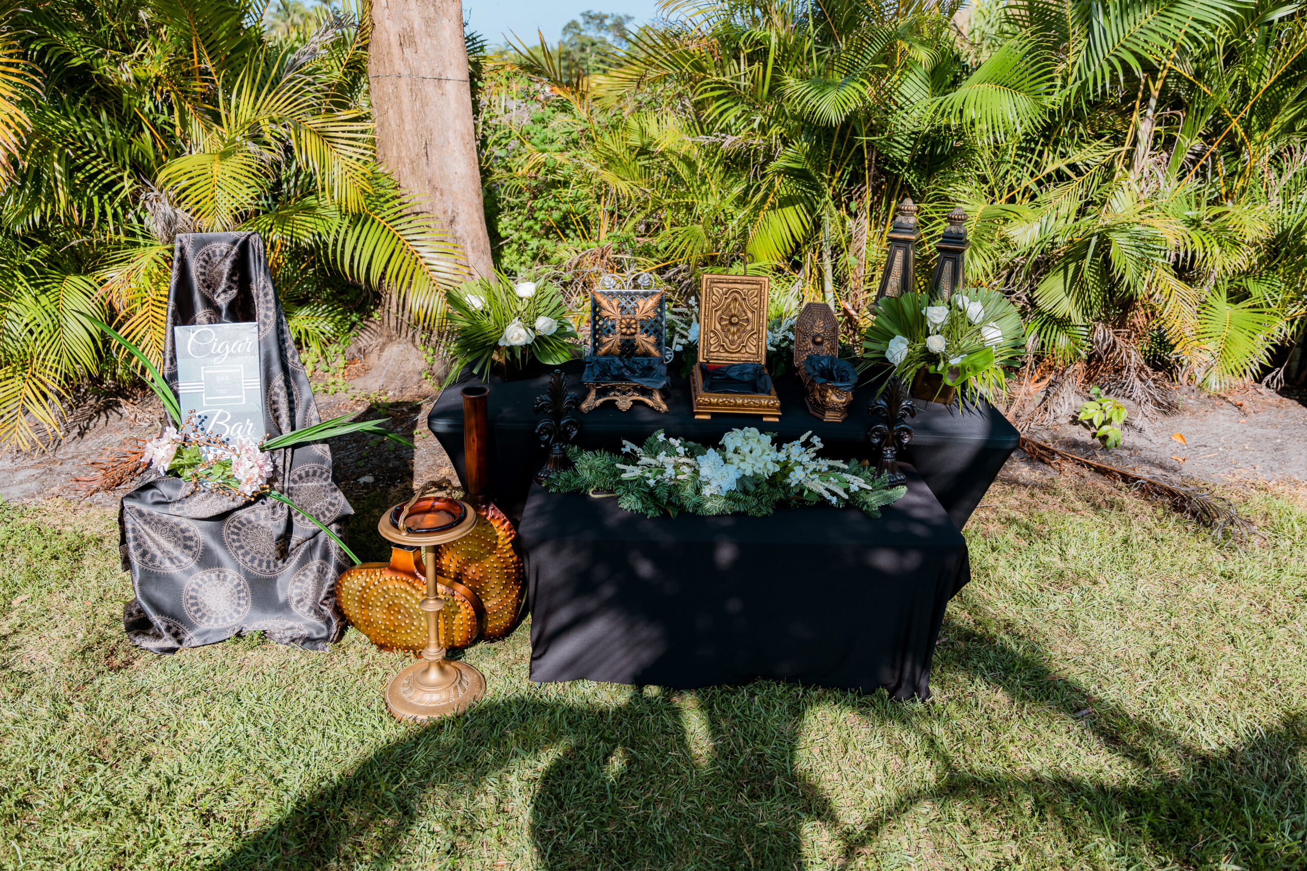 Cigar bar with gold accents, floral greenery, and vintage décor at Saint Patrick Palace in South Florida