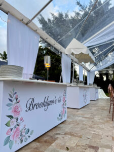 Custom floral food station beneath clear tent at Saint Patrick Palace, designed for Brooklynn’s South Florida quinceañera.