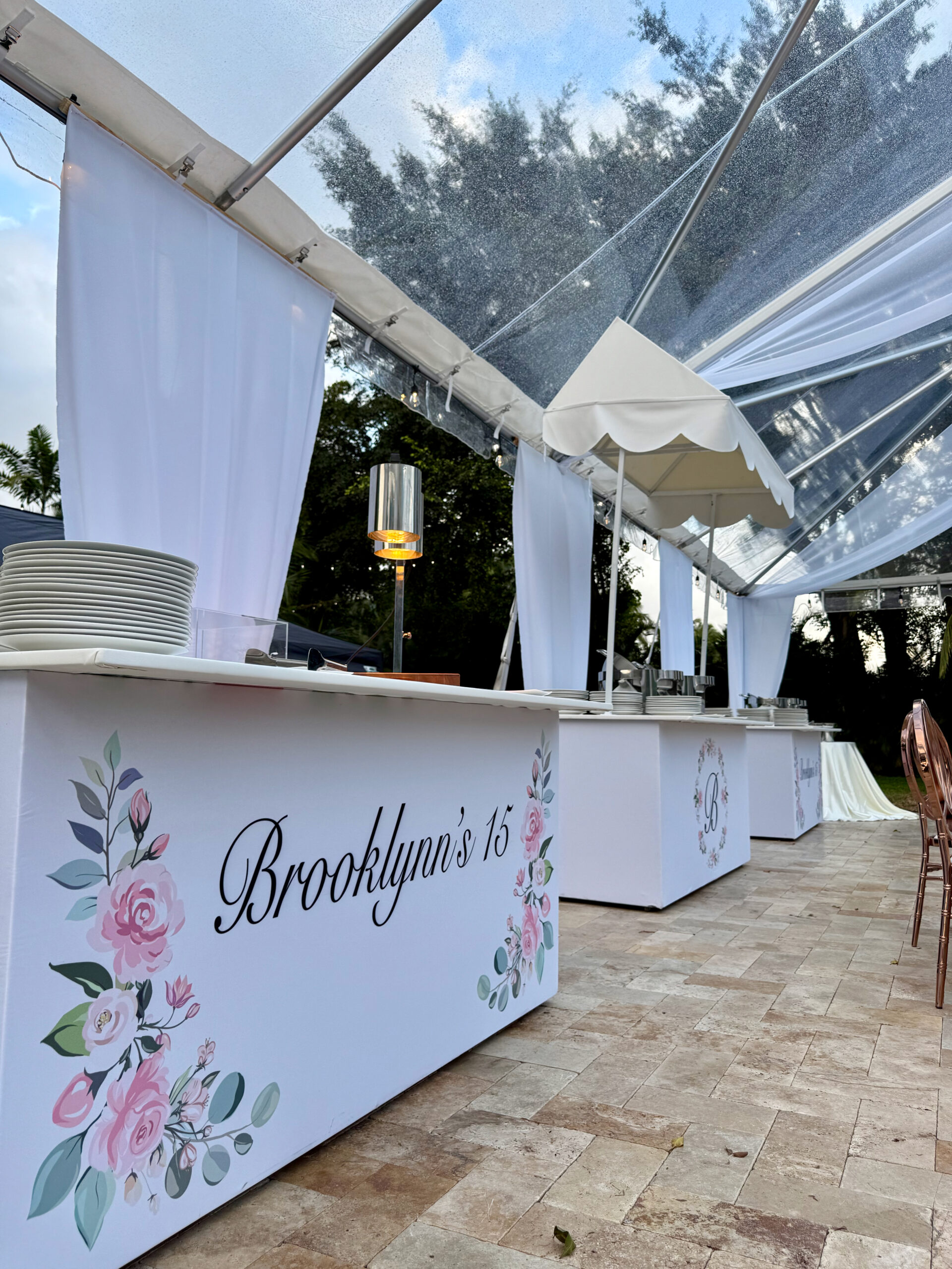Custom floral food station beneath clear tent at Saint Patrick Palace, designed for Brooklynn’s South Florida quinceañera.