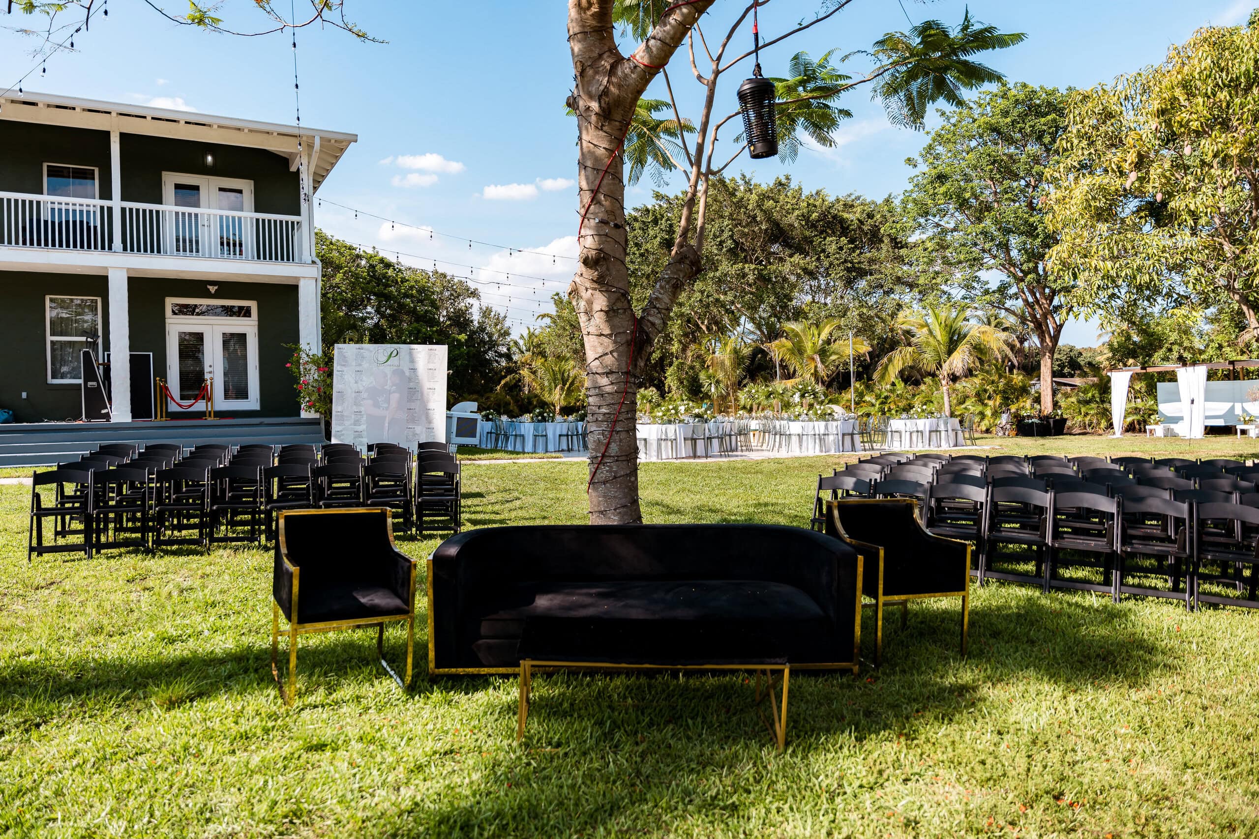 Outdoor wedding lawn setup with ceremony chairs and lounge seating at Saint Patrick Palace in South Florida