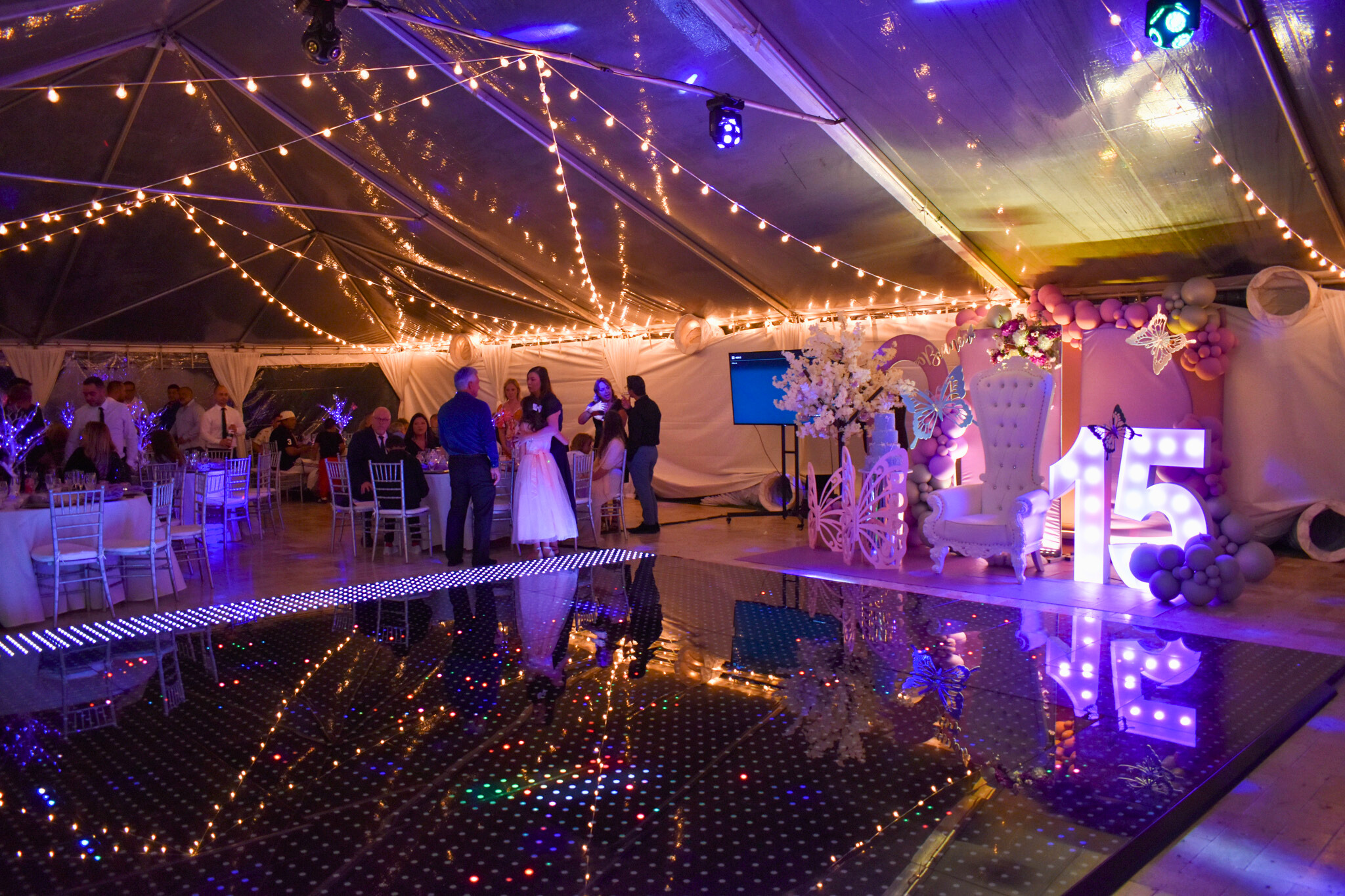 Quinceañera reception with glowing dance floor and décor at luxury South Florida event venue.