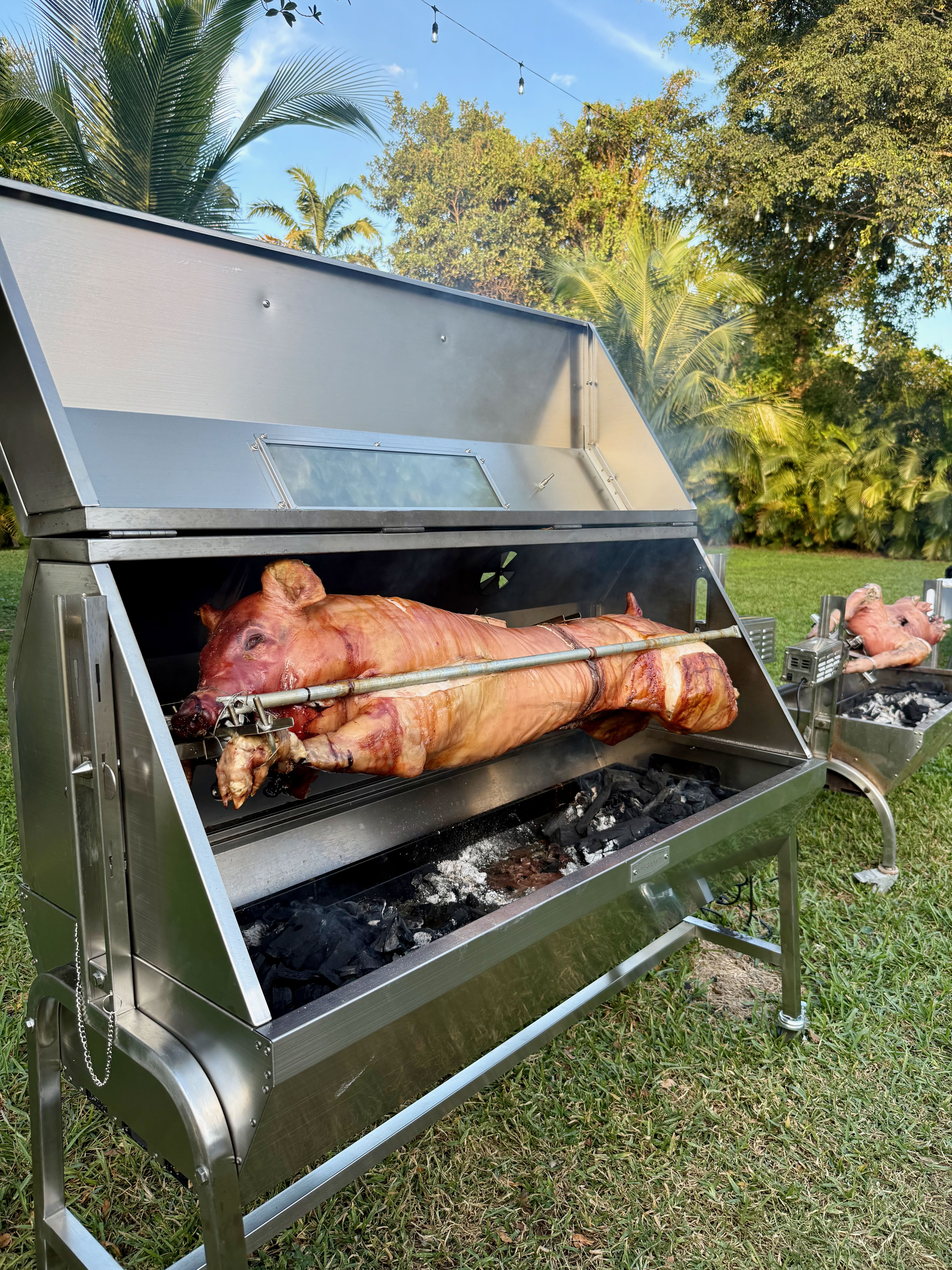 Whole hog spit roast prepared on site for an elevated wedding weekend rehearsal dinner at Saint Patrick Palace in South Florida.