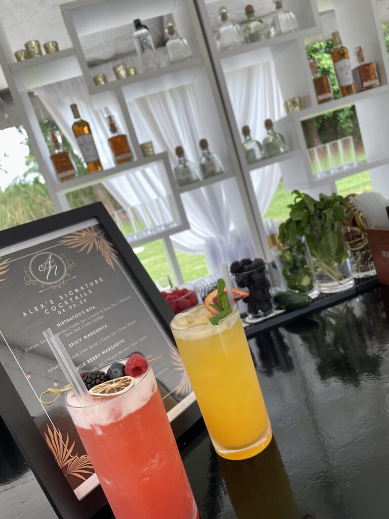 Signature cocktails and custom drink menu for a luxury tropical garden brunch celebrating a 60th birthday.