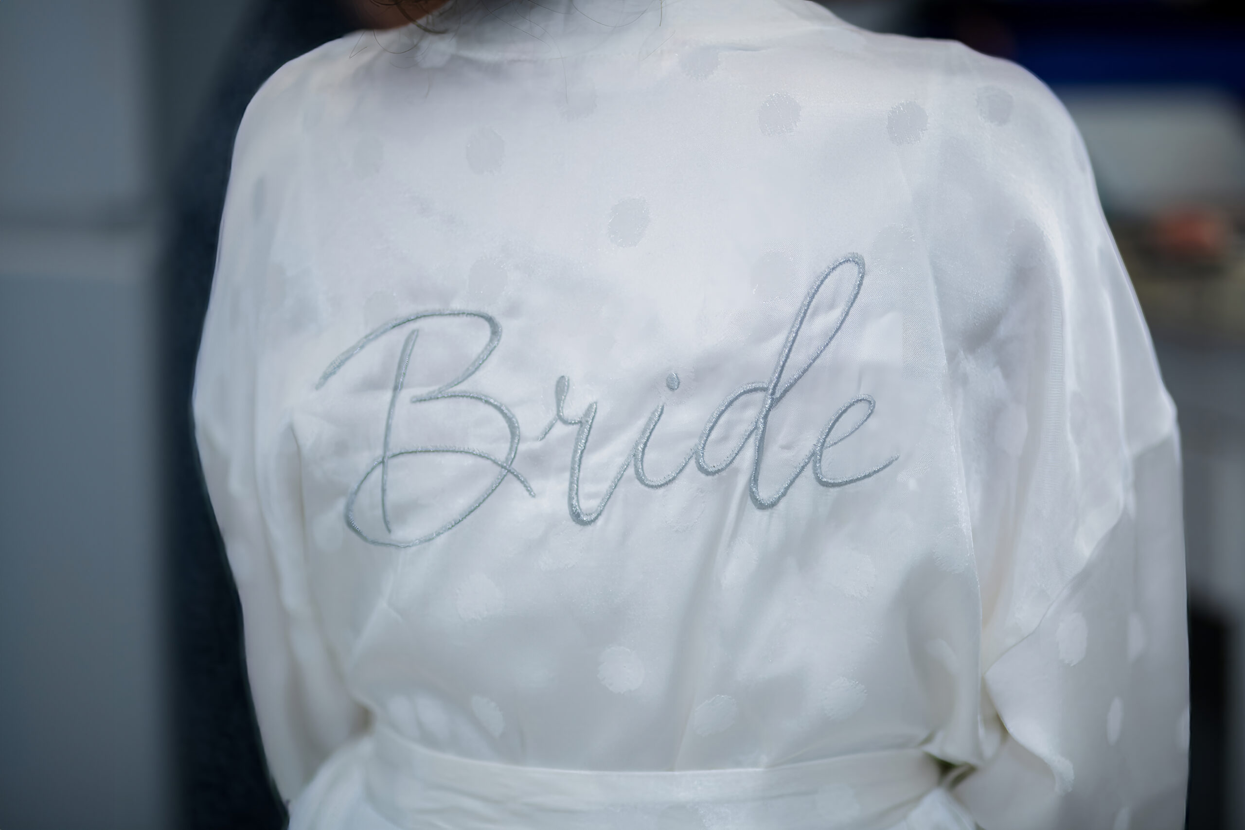 Bride in custom robe and gown in bridal suite at South Florida Airbnb wedding venue, Saint Patrick Palace