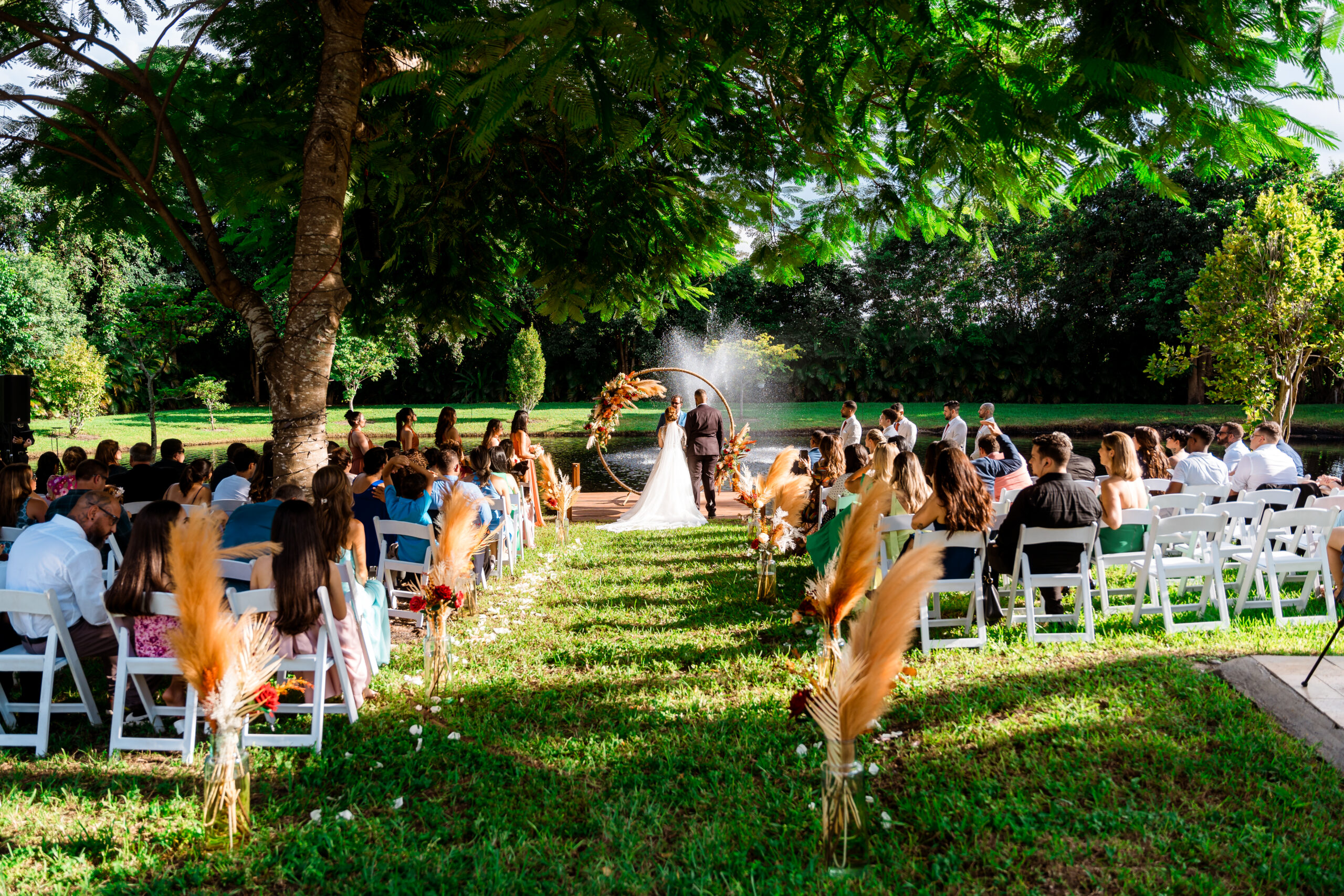Outdoor wedding ceremony at Saint Patrick Palace in South Florida, promoting a glossary of wedding terms for couples.