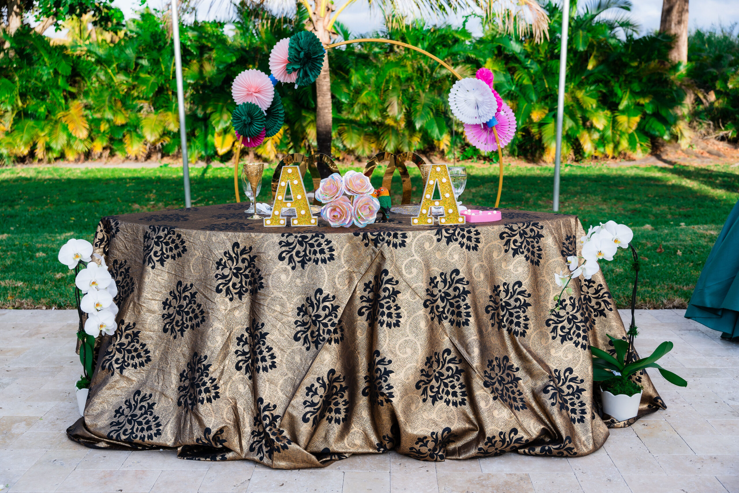 Sweetheart table with gold-and-black linen and orchids at Saint Patrick Palace.