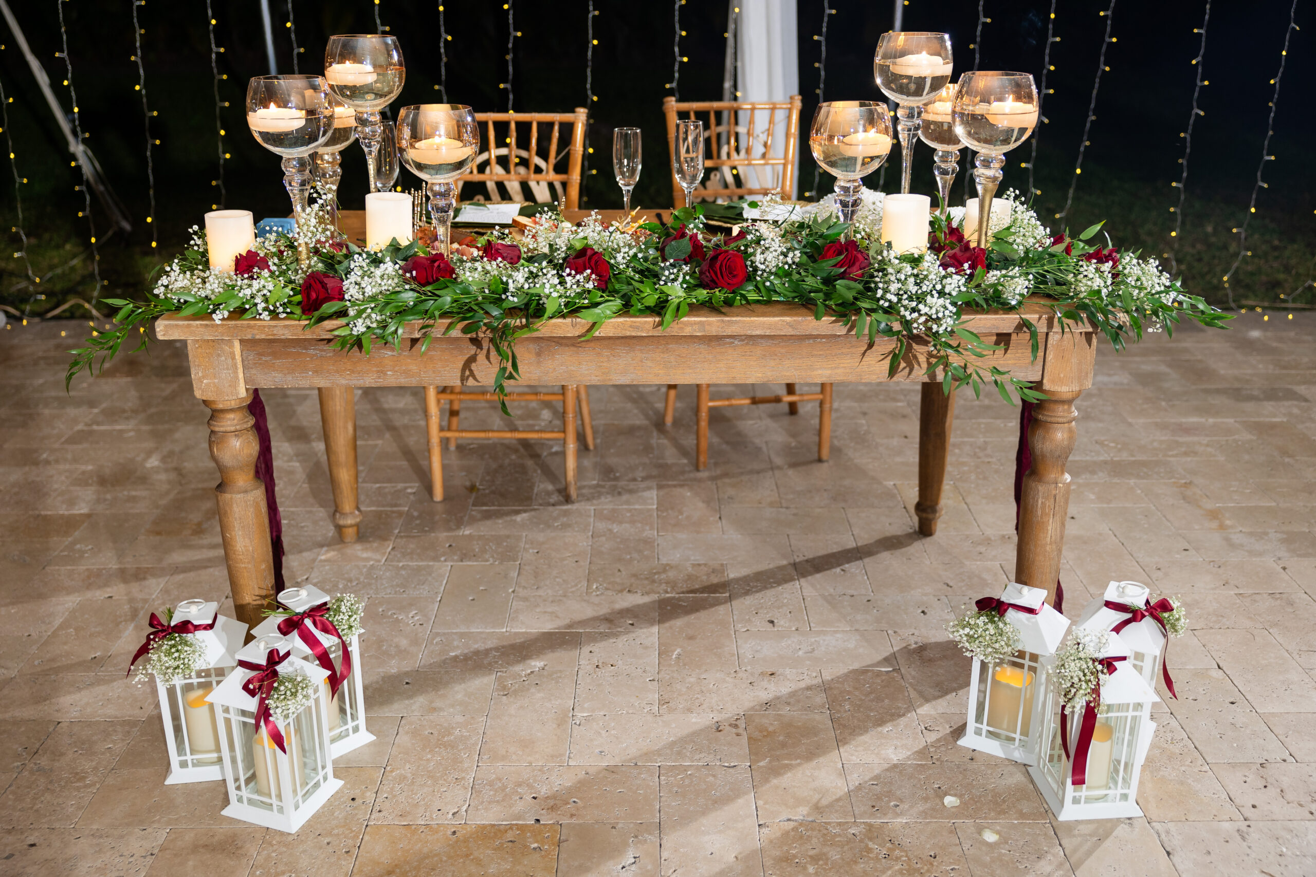 Sweetheart table with candles and floral décor at Saint Patrick Palace, promoting a South Florida wedding glossary blog.