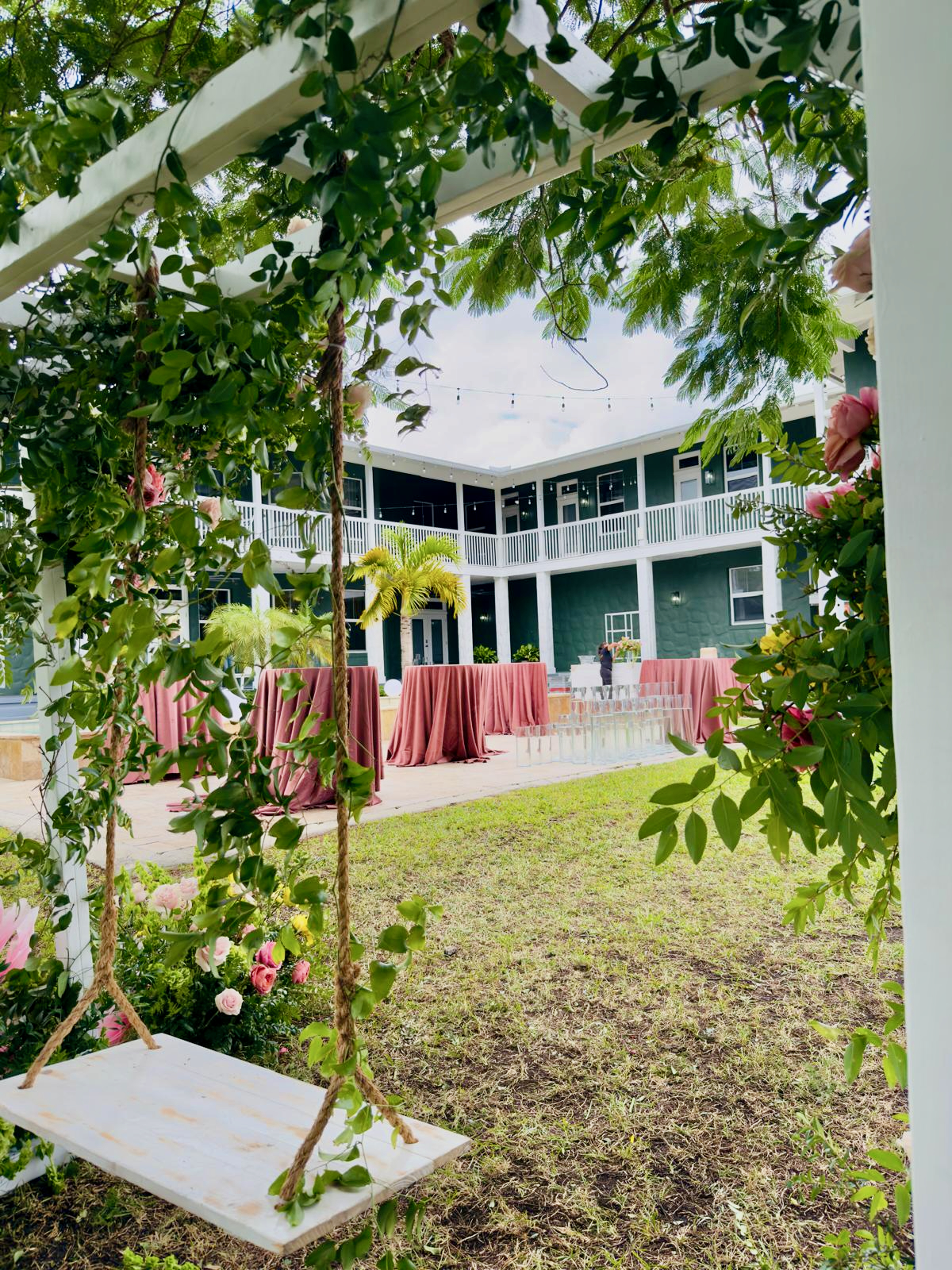 View of Saint Patrick Palace courtyard framed by floral swing greenery.