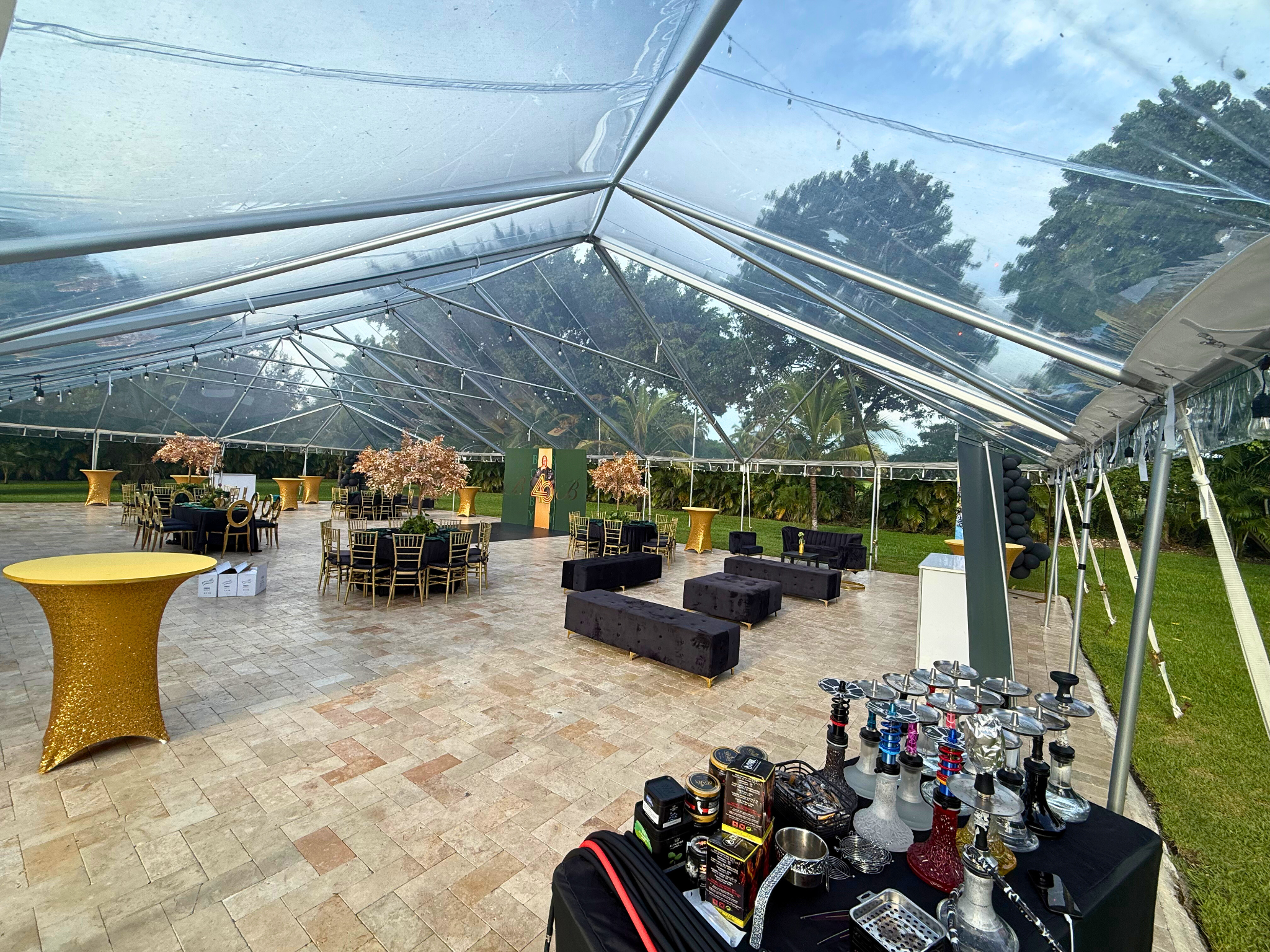 Luxury tented reception with hookah lounge, gold décor, and elegant seating at Saint Patrick Palace.