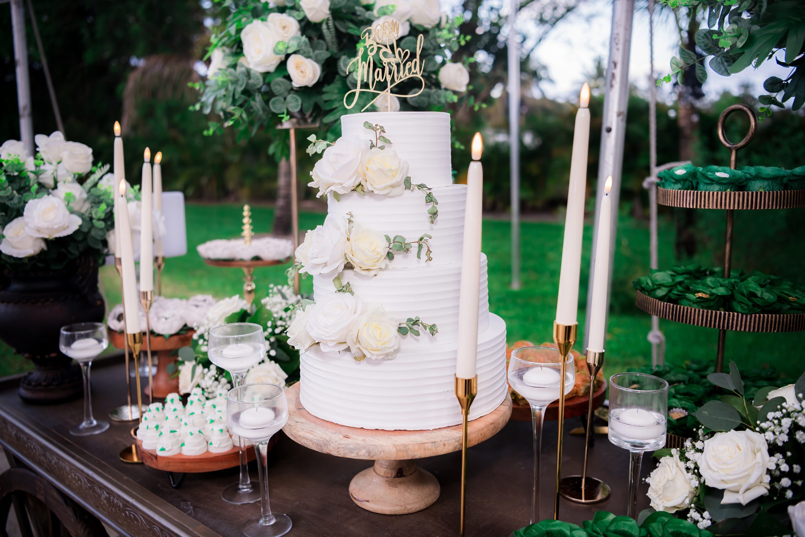 Elegant white wedding cake with floral décor at Saint Patrick Palace, promoting a South Florida wedding glossary blog.
