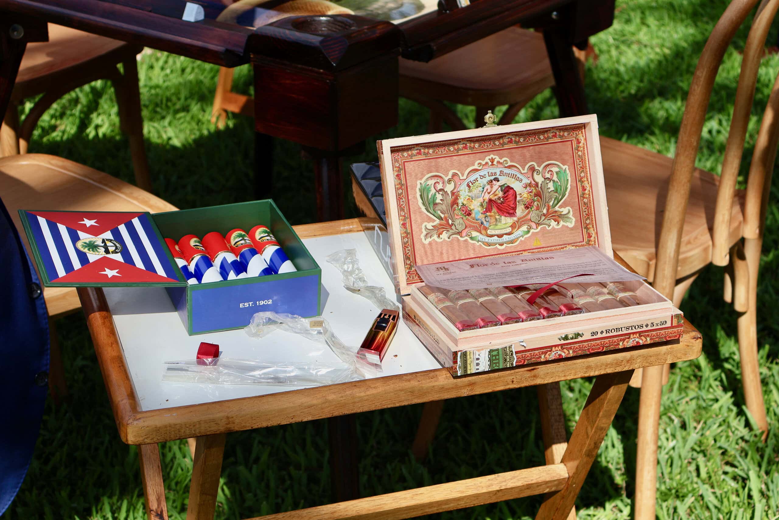 Cigar lounge display with premium cigars at outdoor wedding reception in Davie Florida