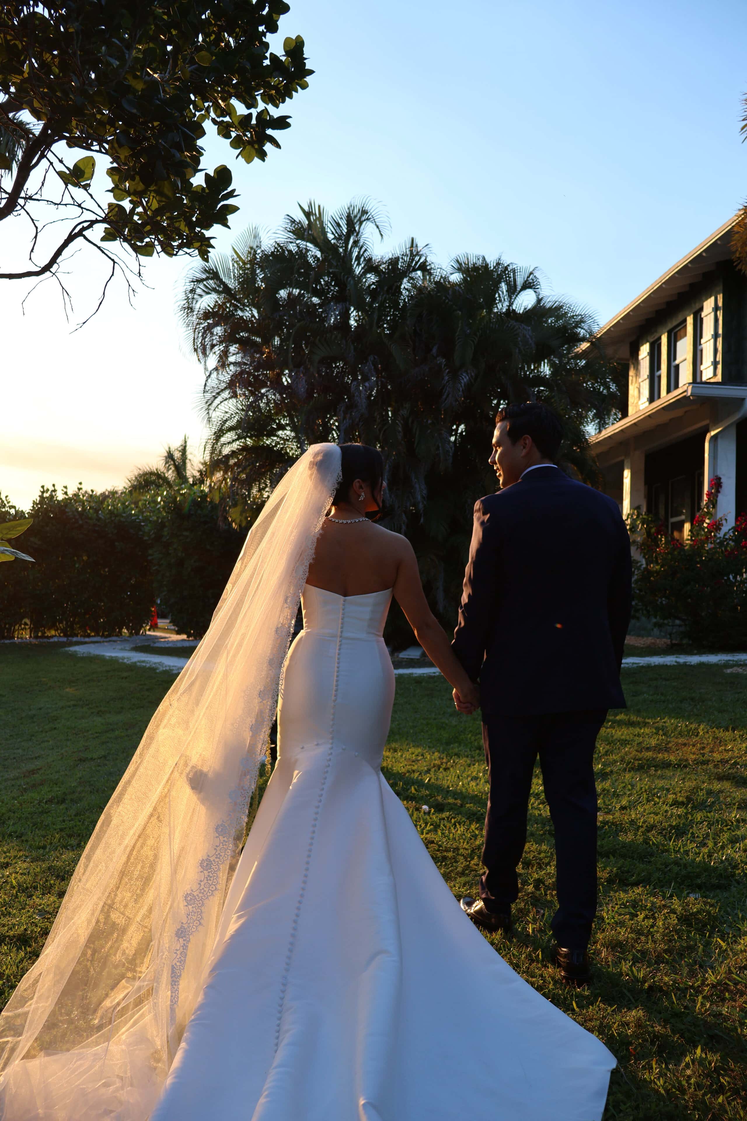 Bride and groom walking at sunset at South Florida wedding venue Saint Patrick Palace