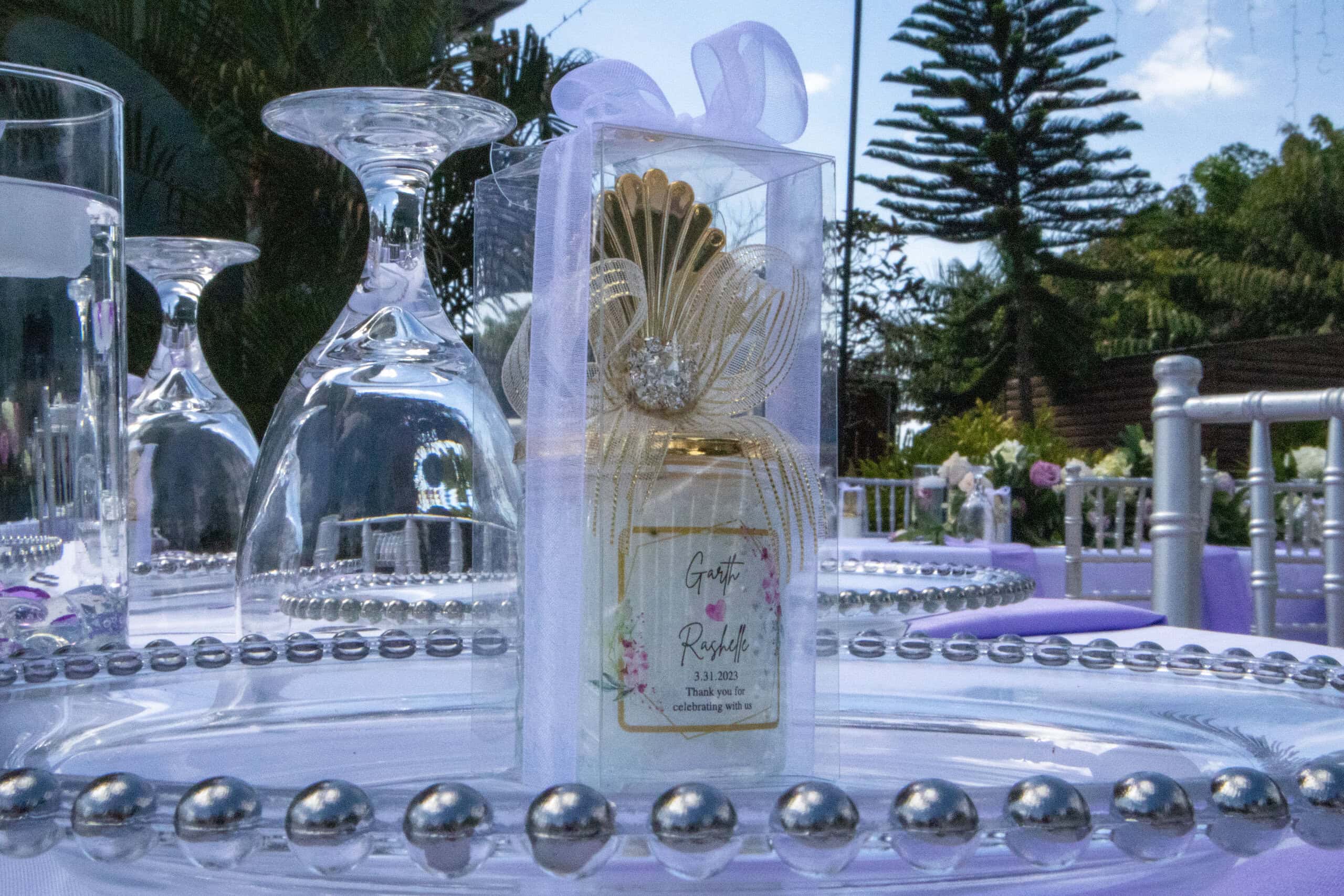 Personalized wedding favor display with decorative table setup at outdoor reception in Davie Florida