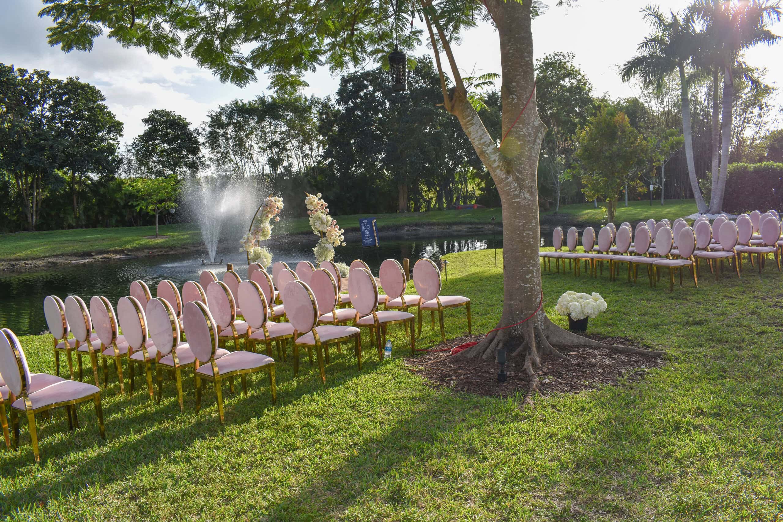 Overhead view of wedding ceremony setup on dock with floral arch at private estate venue in South Florida