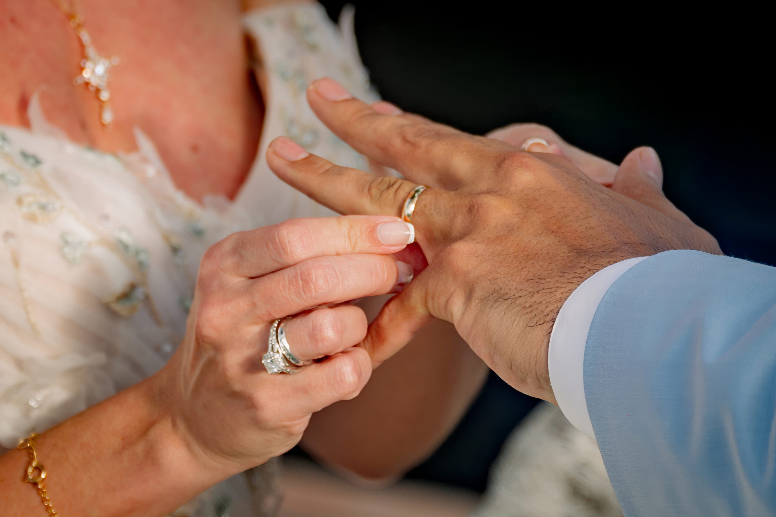 Close-up of wedding ring exchange at Saint Patrick Palace, a luxury Airbnb wedding venue in South Florida.
