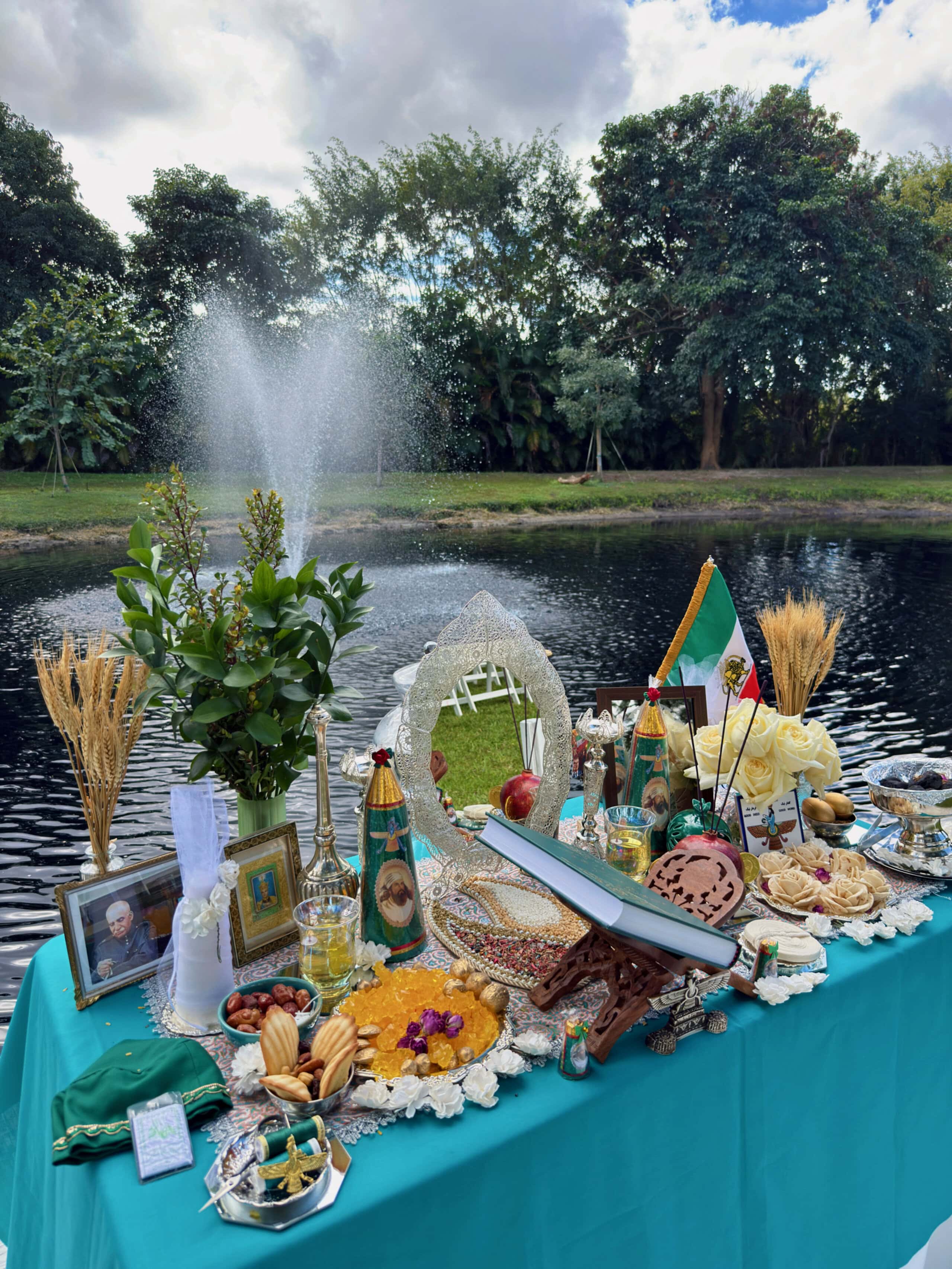 Zoroastrian wedding sofreh table with symbolic items and offerings set beside waterfront at Saint Patrick Palace